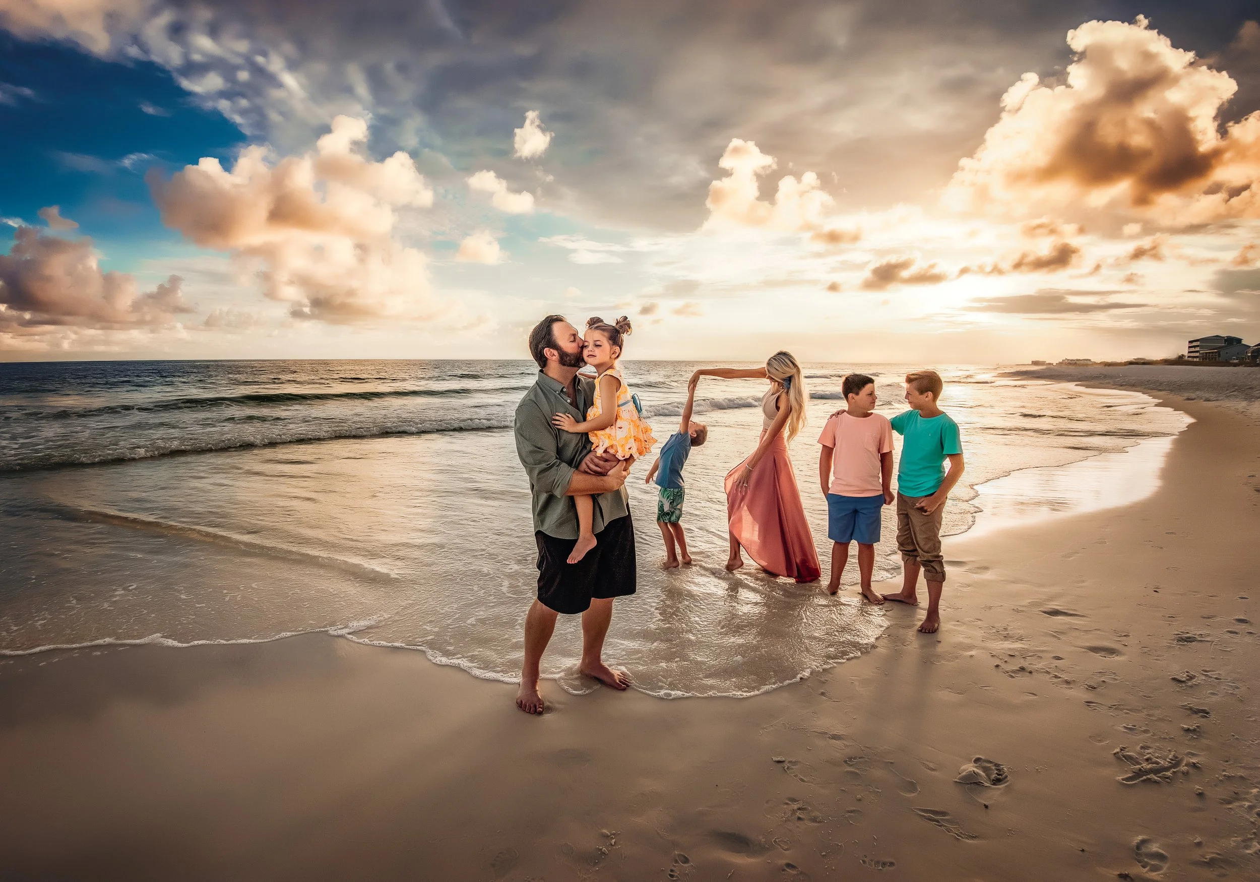 A full family capturing a genuine connection and natural movement in the emerald coast surf near Rosemary Beach, Florida.