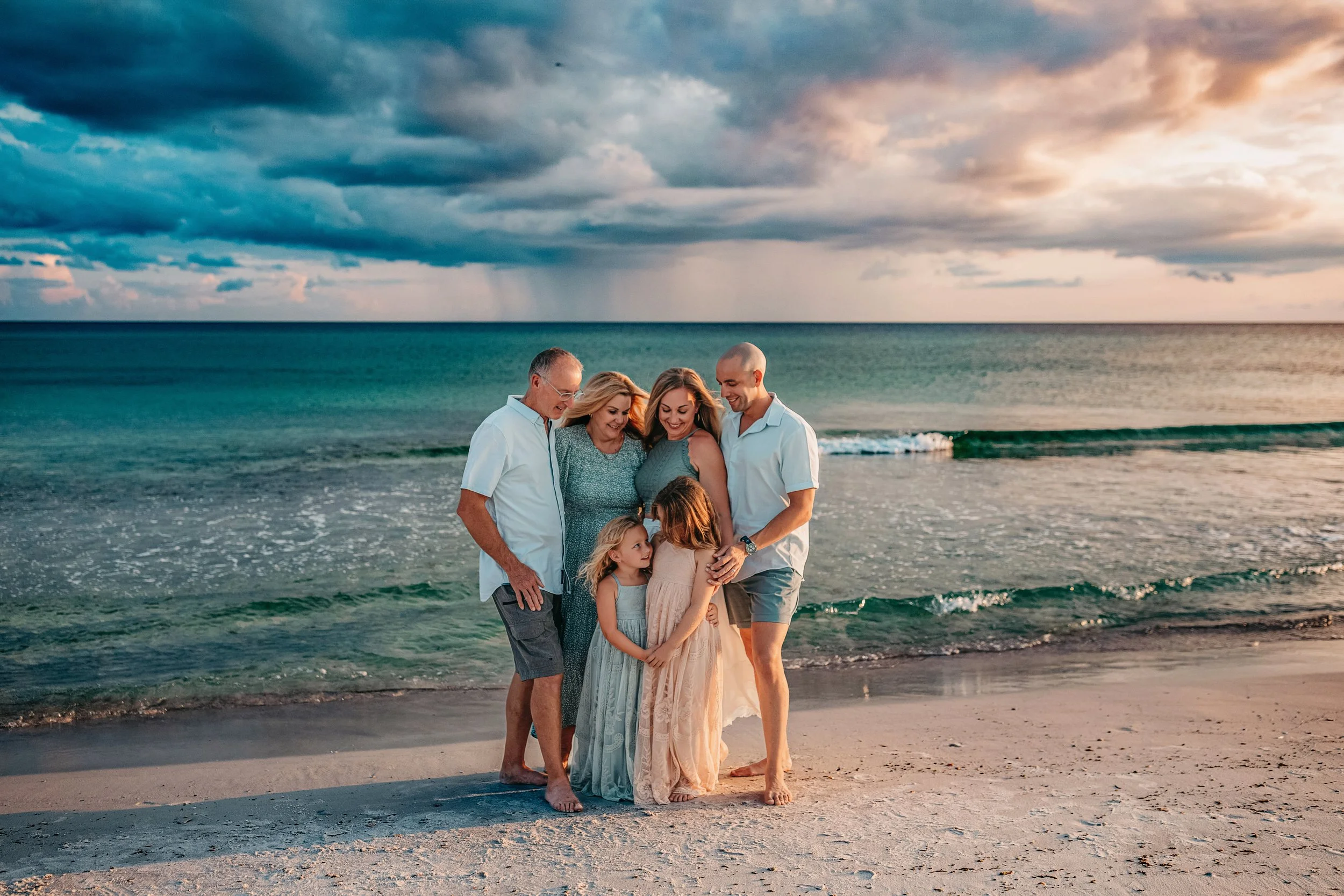 Dramatic sky over an extended family beach portrait at Inlet Beach photographed by a 30A beach photographer