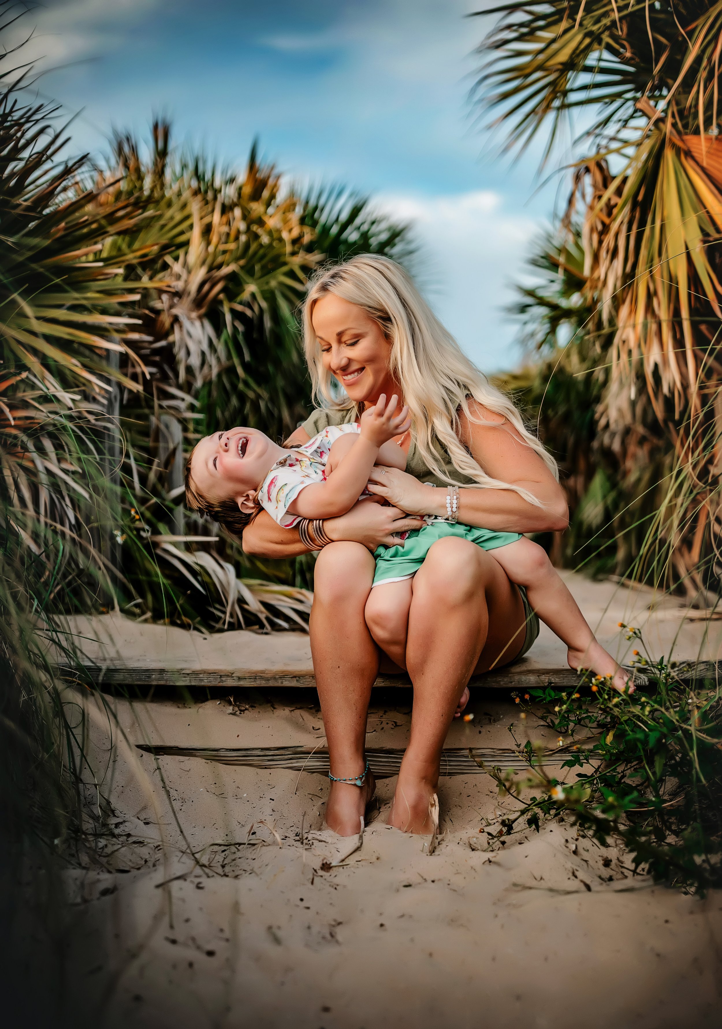 Mom laughing with toddler during candid Rosemary Beach family photography session on 30A