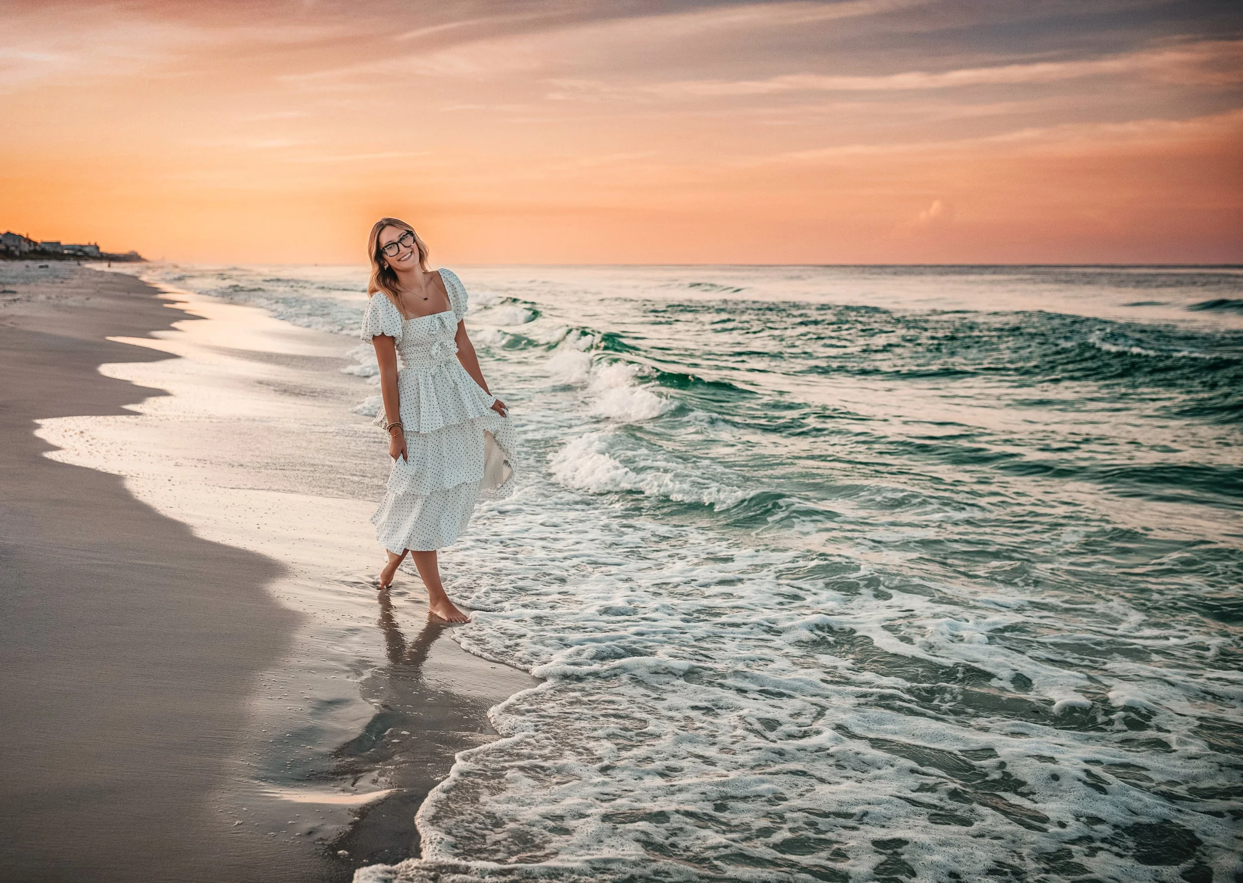 Coastal editorial portrait on 30A at sunset featuring natural movement, flowing wardrobe, and soft pastel skies, luxury feminine portrait style popular in Alys Beach and Rosemary Beach.