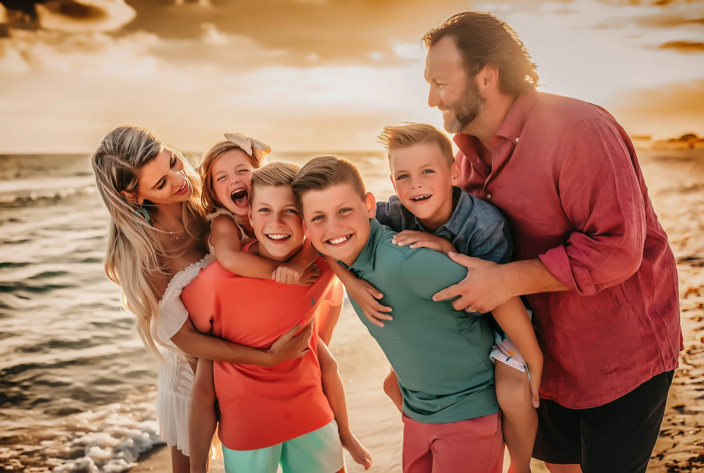 Large family embracing in Destin during their beach session at sunset