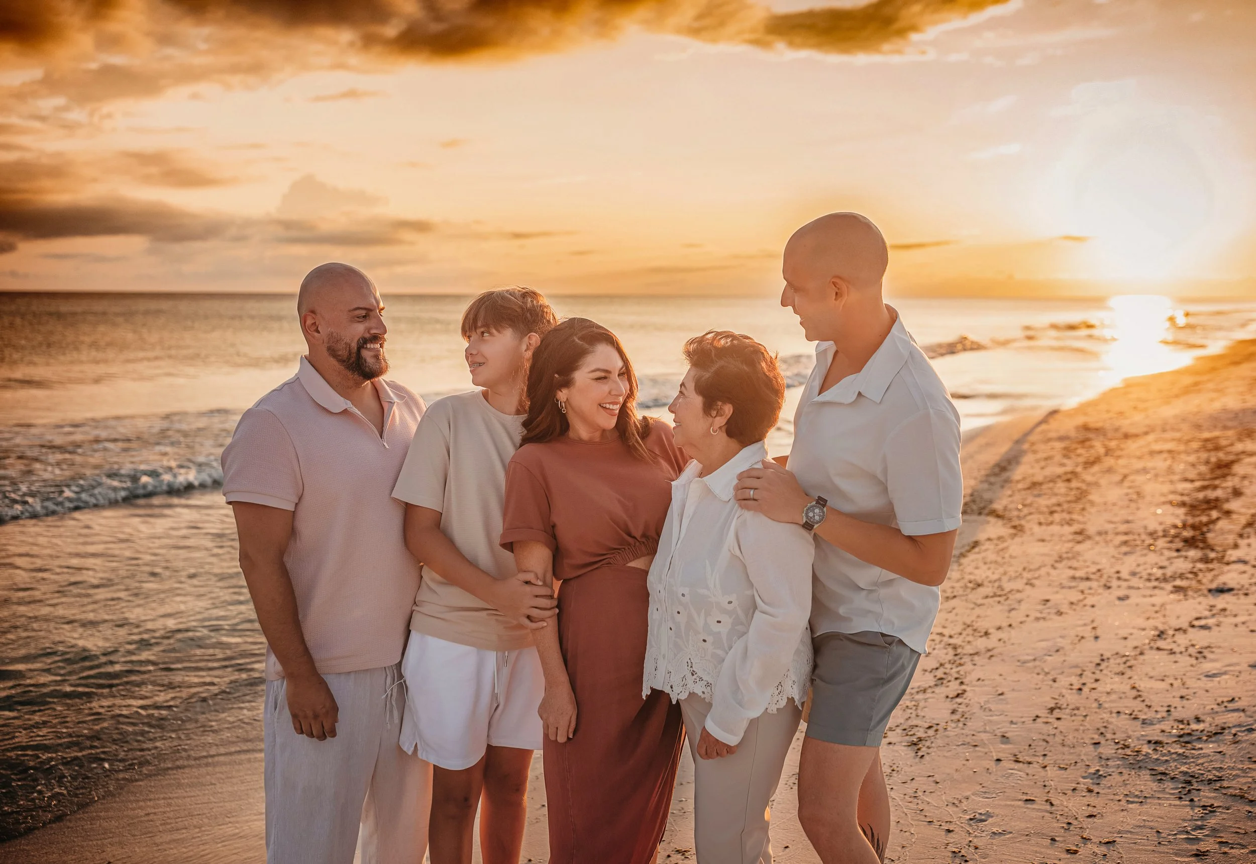 Candid extended family moment at the shoreline during a sunset family beach session on 30A