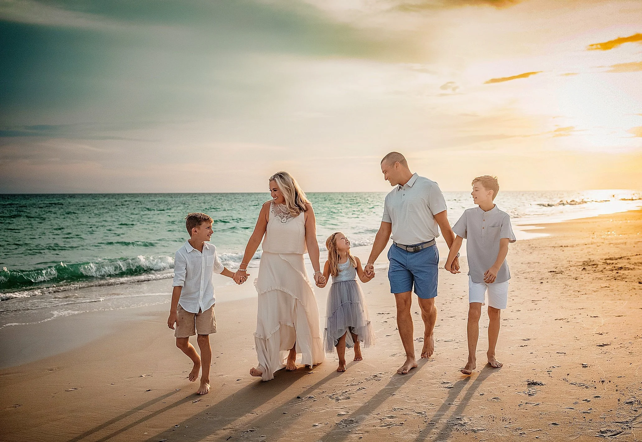 Extended family portraits on 30A during sunset with coordinated neutrals, candid connection, and ocean backdrop. Popular for multigenerational vacations and reunion trips in Rosemary Beach and WaterSound.
