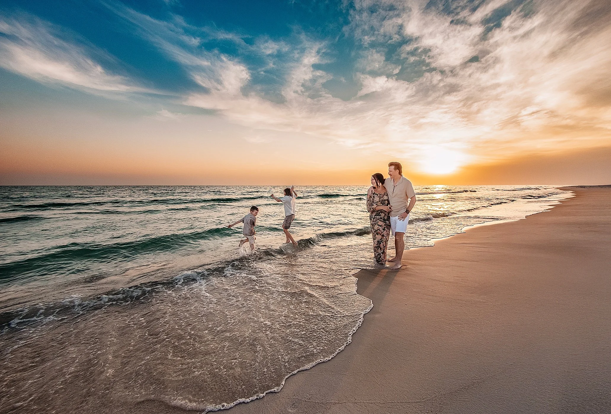 Family in coordinated beach outfits on 30A Florida at golden hour — 30A beach photo outfits style guide