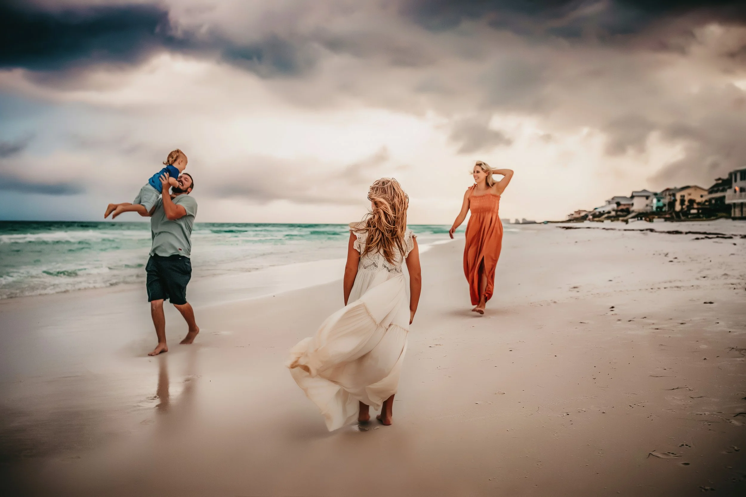 Family of four playing during their beach session at Dune Allen Beach
