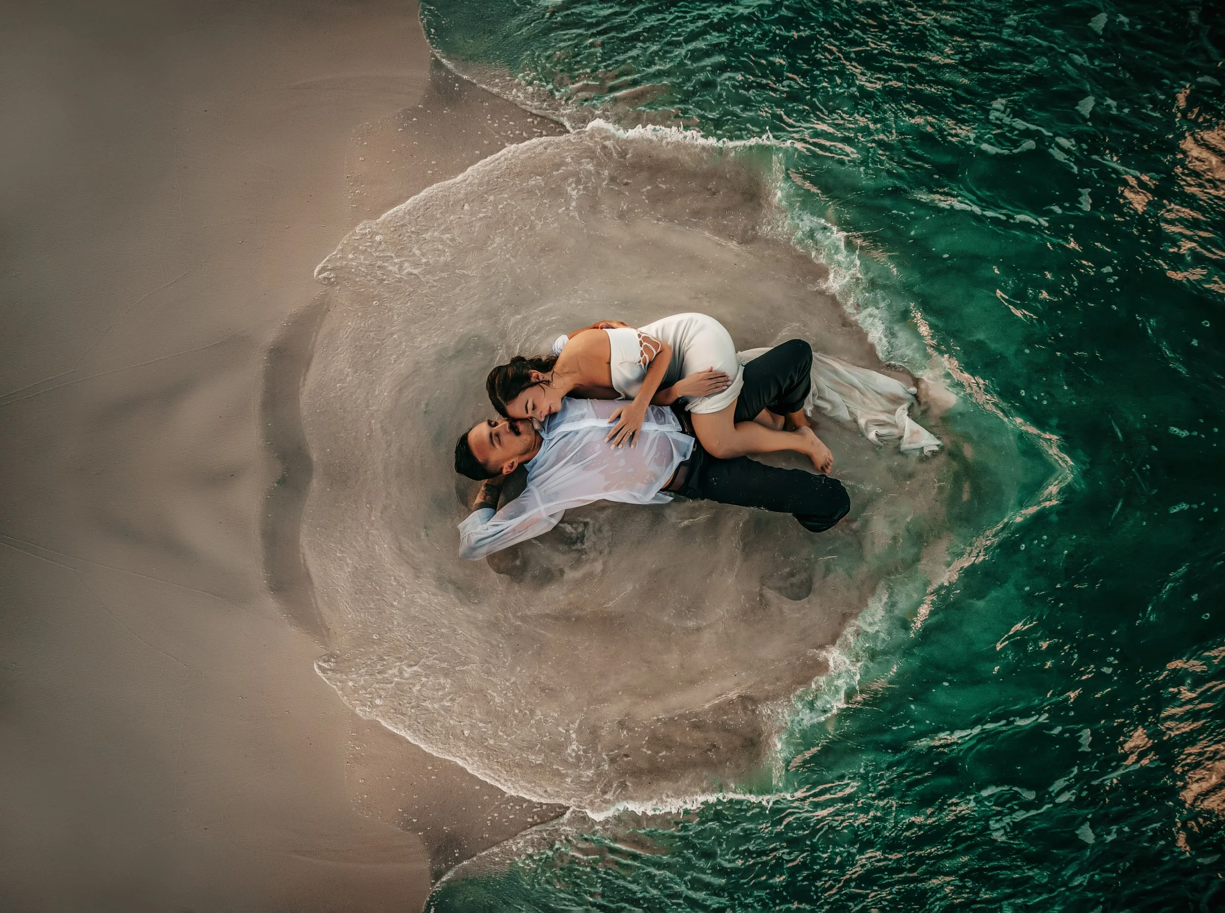 30A couple laying on the beach during their engagement session