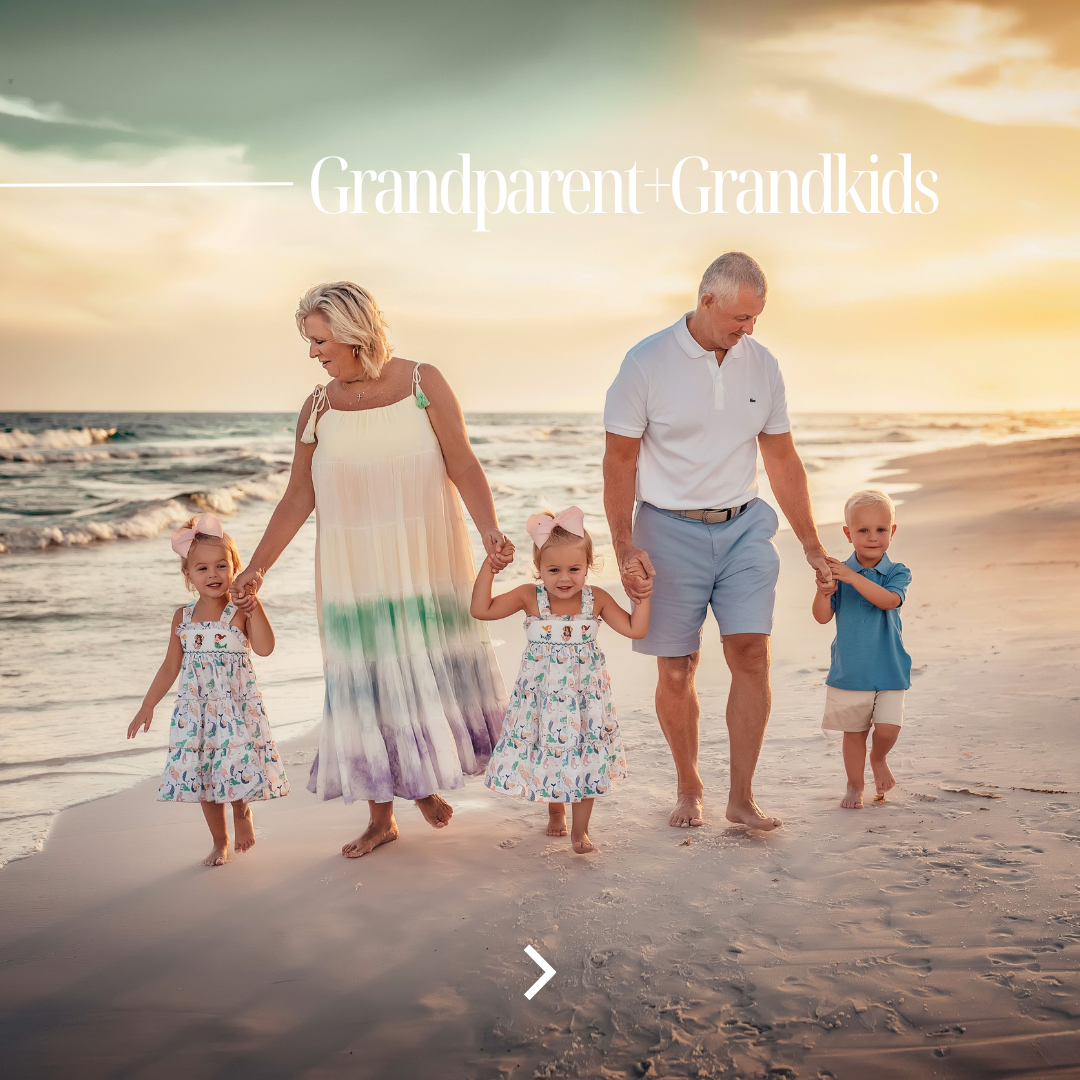 Grandparents walking hand in hand with three young grandchildren in matching mermaid dresses and pink bows along the 30A shoreline at sunset, captured by 30A beach photographer Lisa Marie