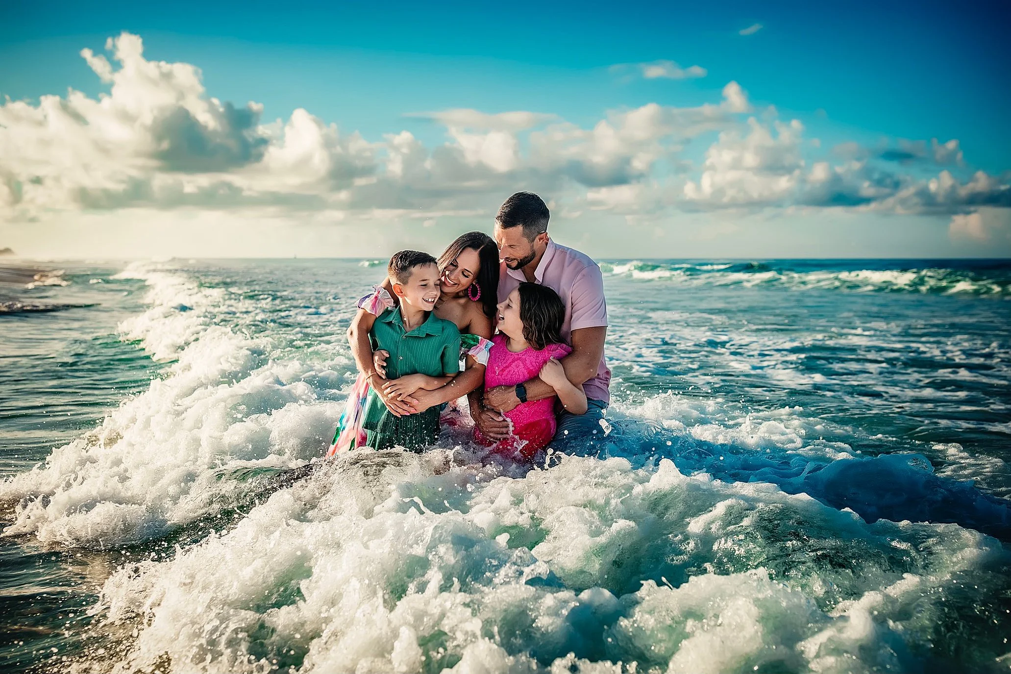 Family laughing during candid beach session on 30A Emerald Coast