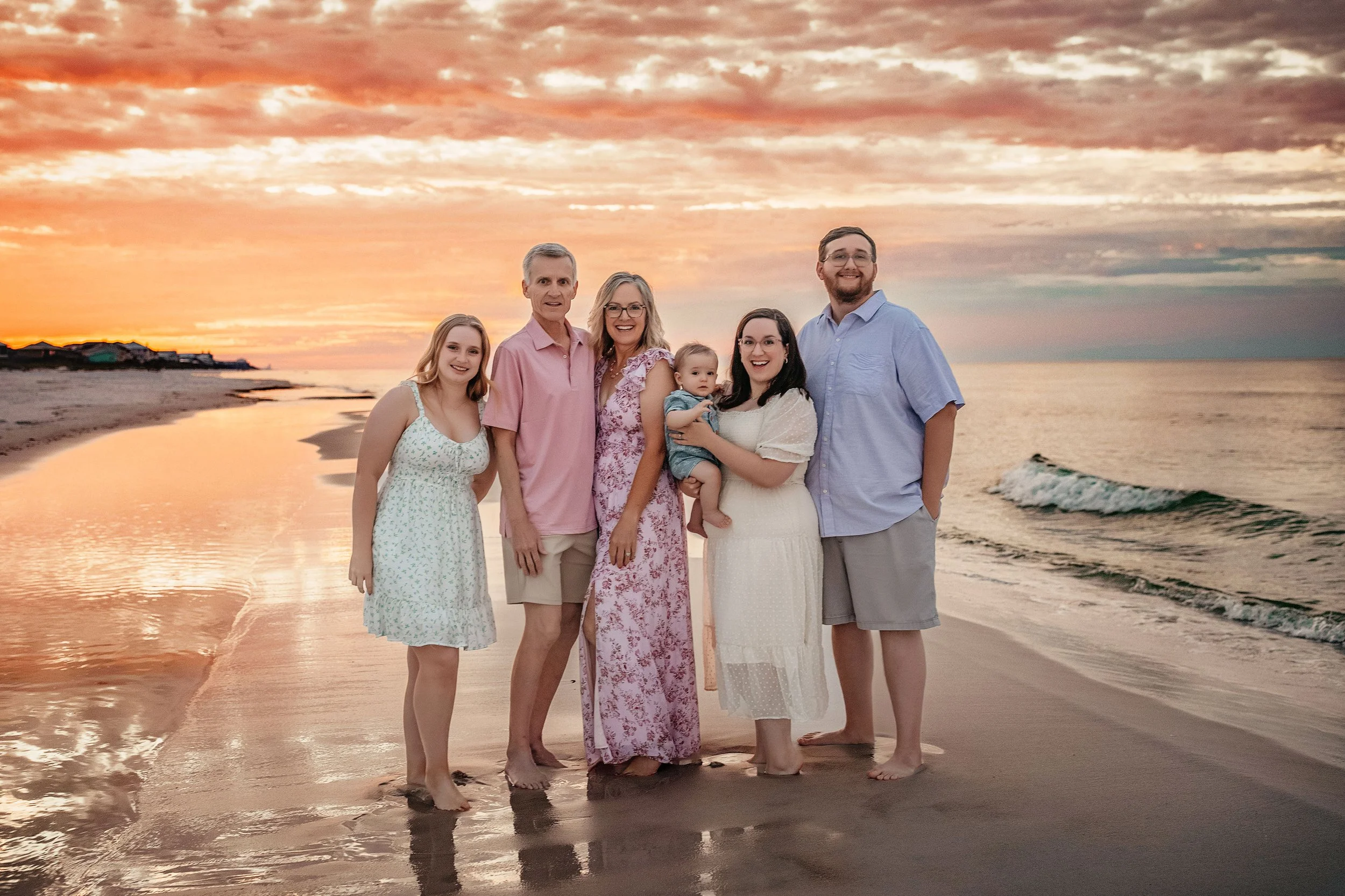 Family of five in coordinated outfits during sunset beach session at Santa Rosa Beach Florida