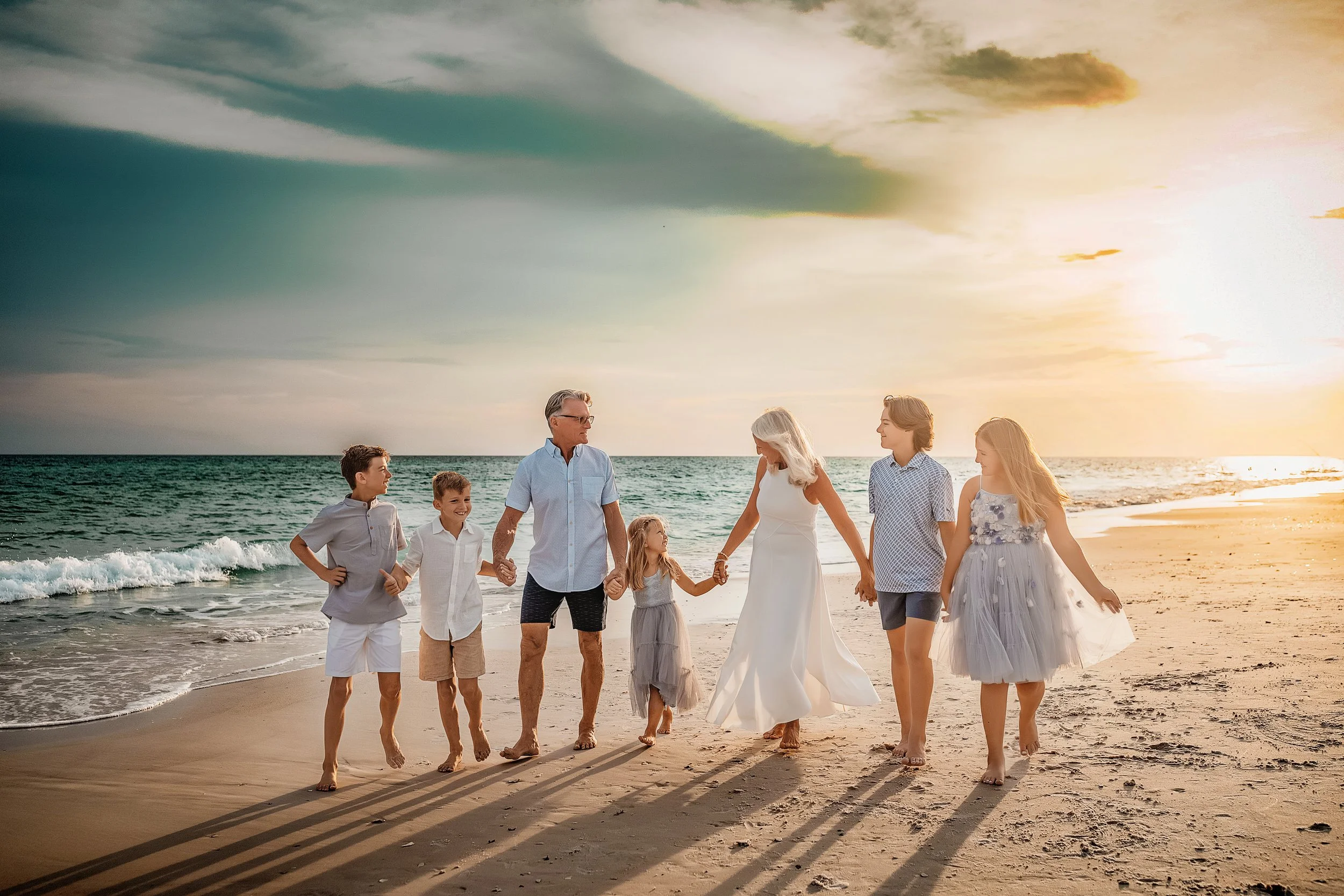 Family portraits at sunset on 30A with barefoot coastal movement, warm neutrals, and candid lifestyle pacing. Popular for vacation sessions in Seagrove and WaterColor.
