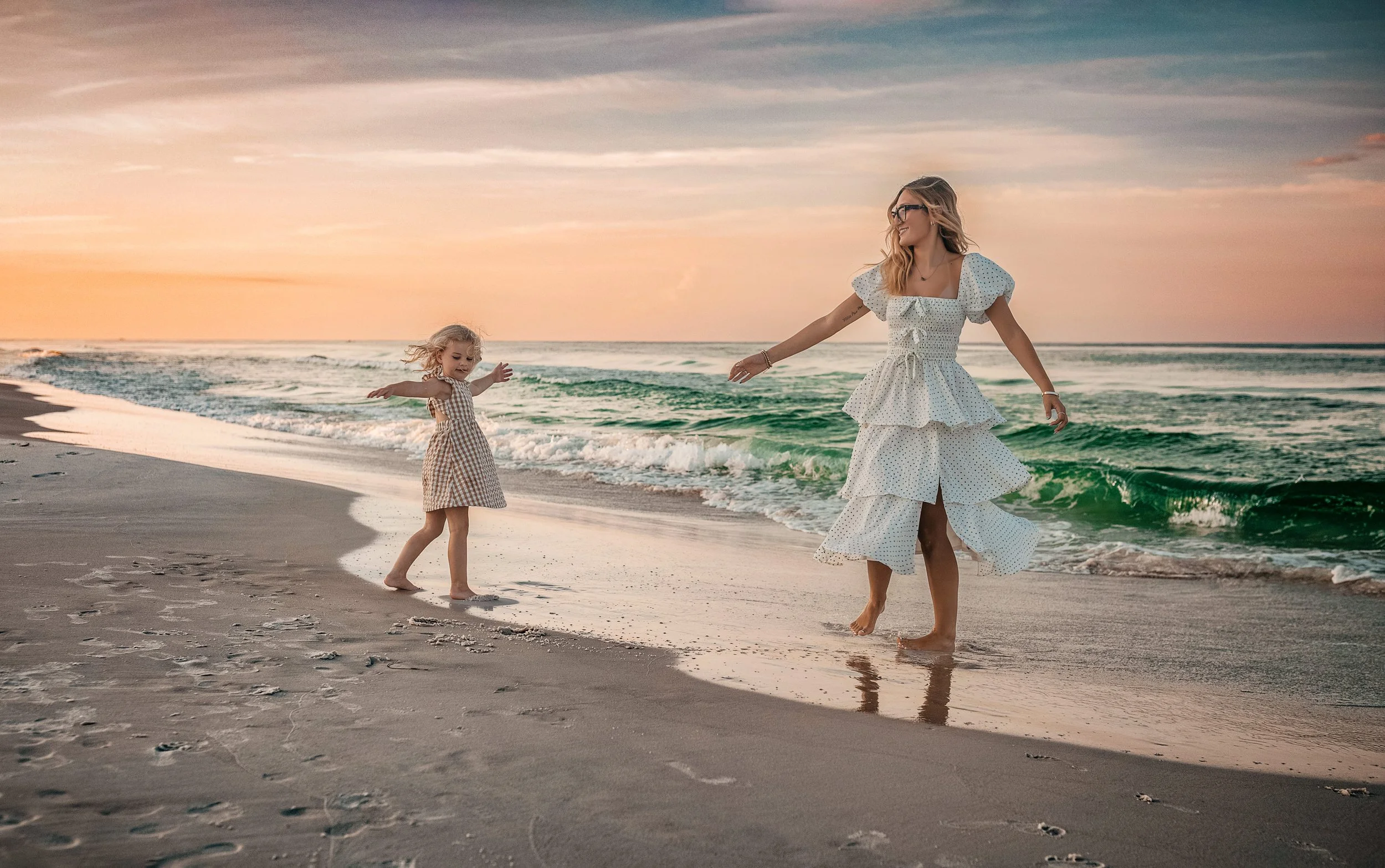 Sisters twirling during their 30A sunrise beach family session