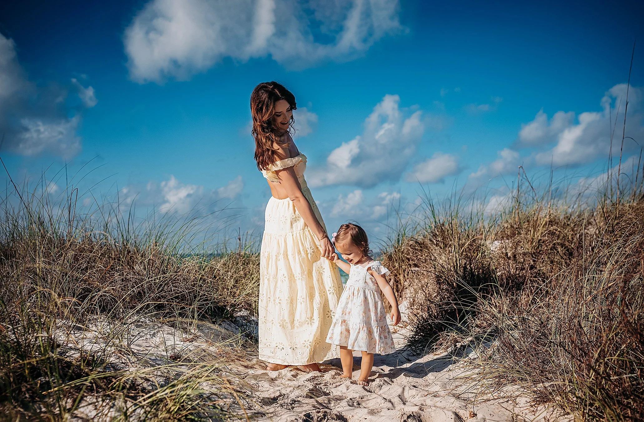 Family portrait during a half beach session on Panama City Beach captured in bright morning light.
