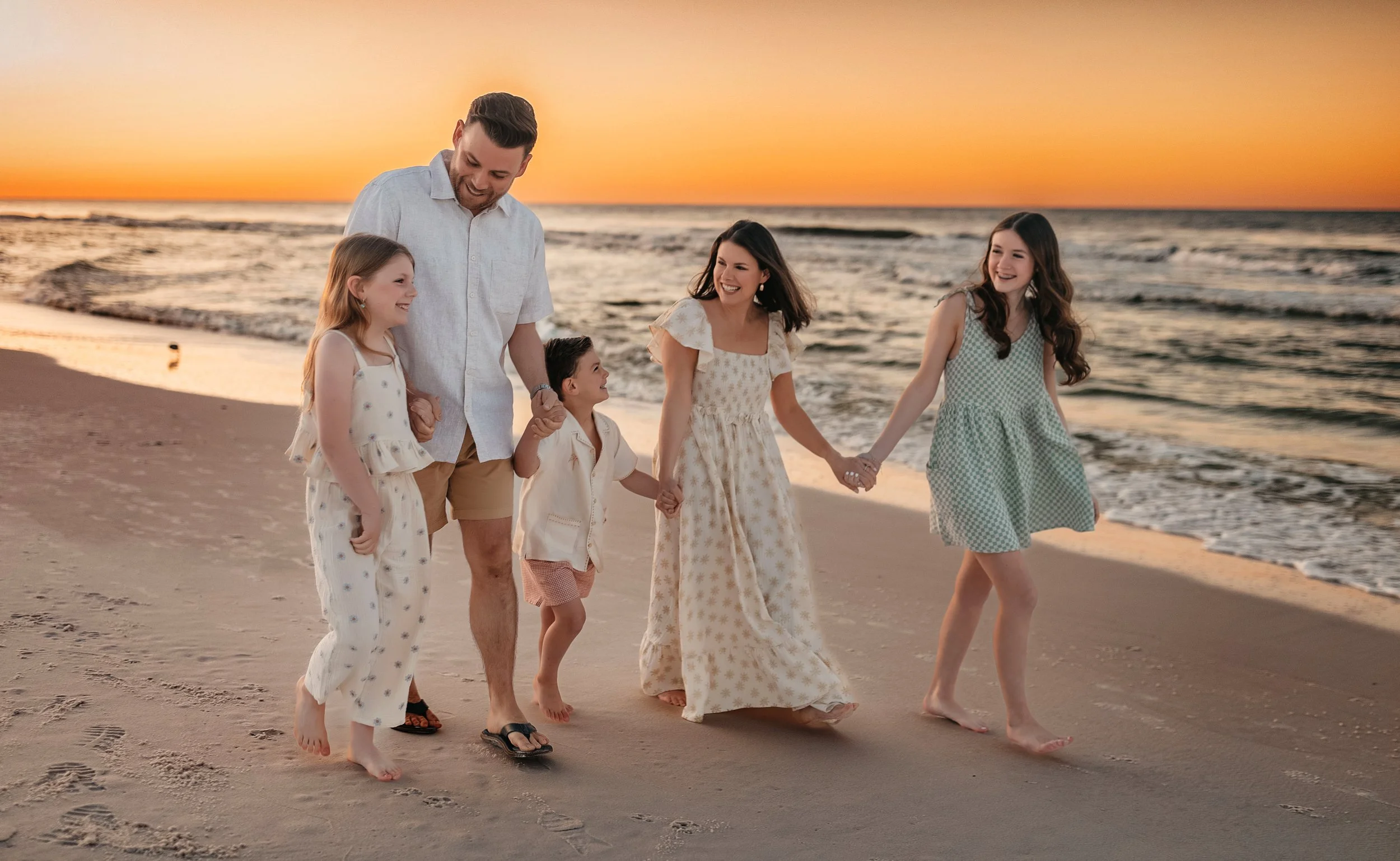 Sunset 30A beach session featuring candid movement, connected posing, and warm editorial tones, perfect for lifestyle family photos during vacation in Seaside or WaterColor.