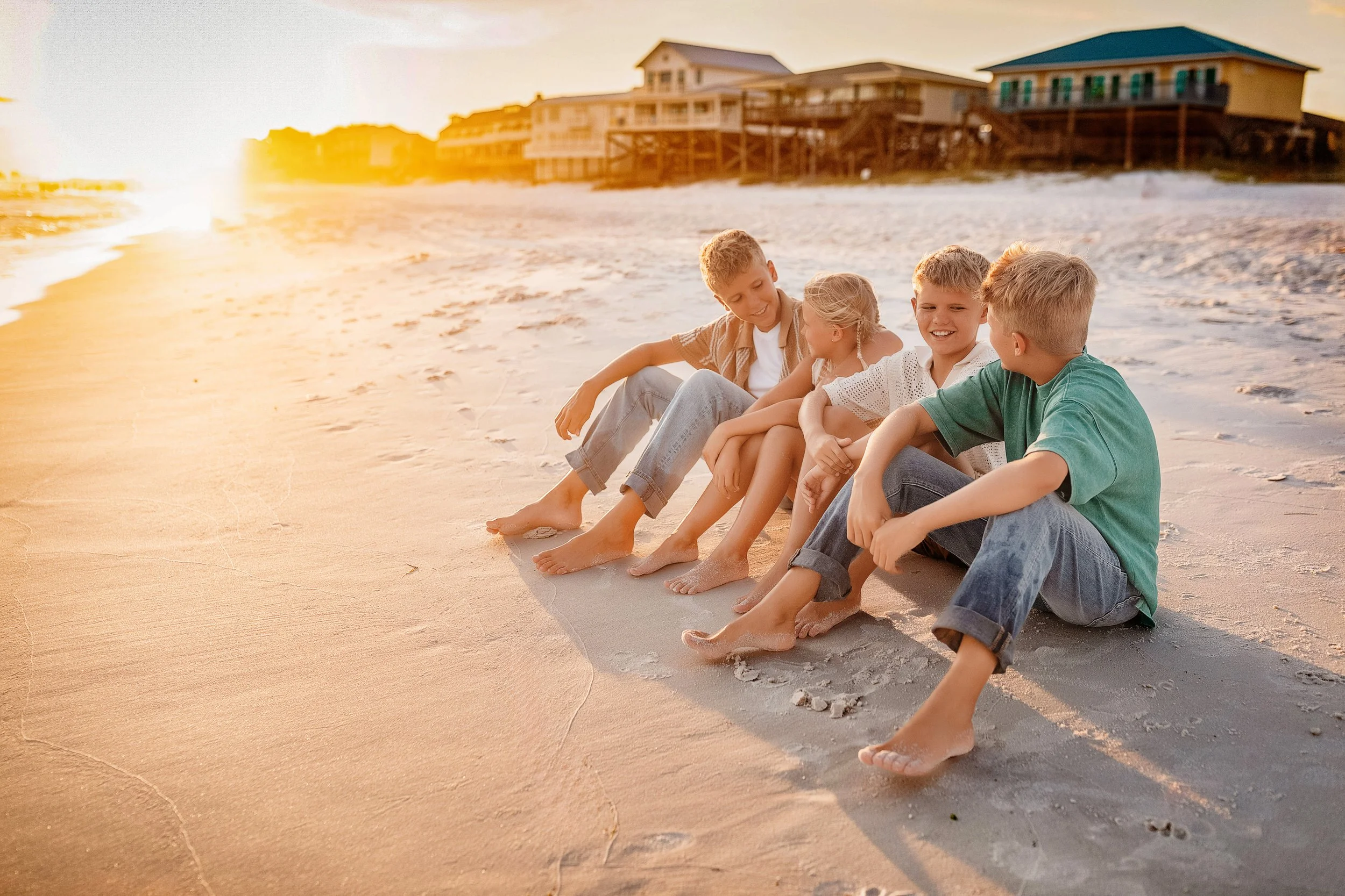 Group of boys sitting on the wide shore near Rosemary Beach dunes, showcasing the relaxed escape and unhurried rhythm of a 30A family session.