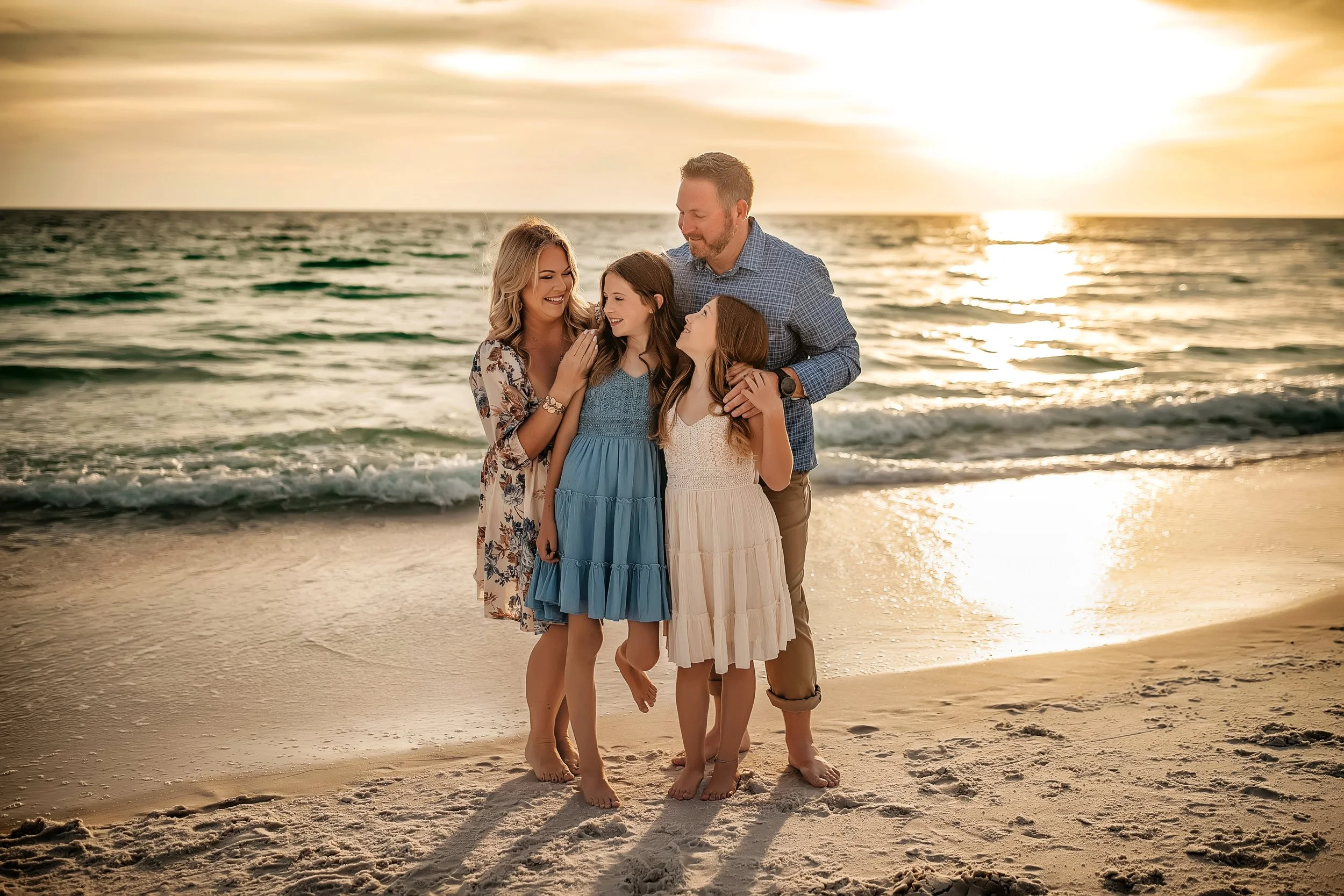 Lifestyle family portraits on 30A with barefoot sunset posing, warm coastal color, and candid connection. Popular for summer vacation sessions and milestone trips in WaterColor and Seagrove.
