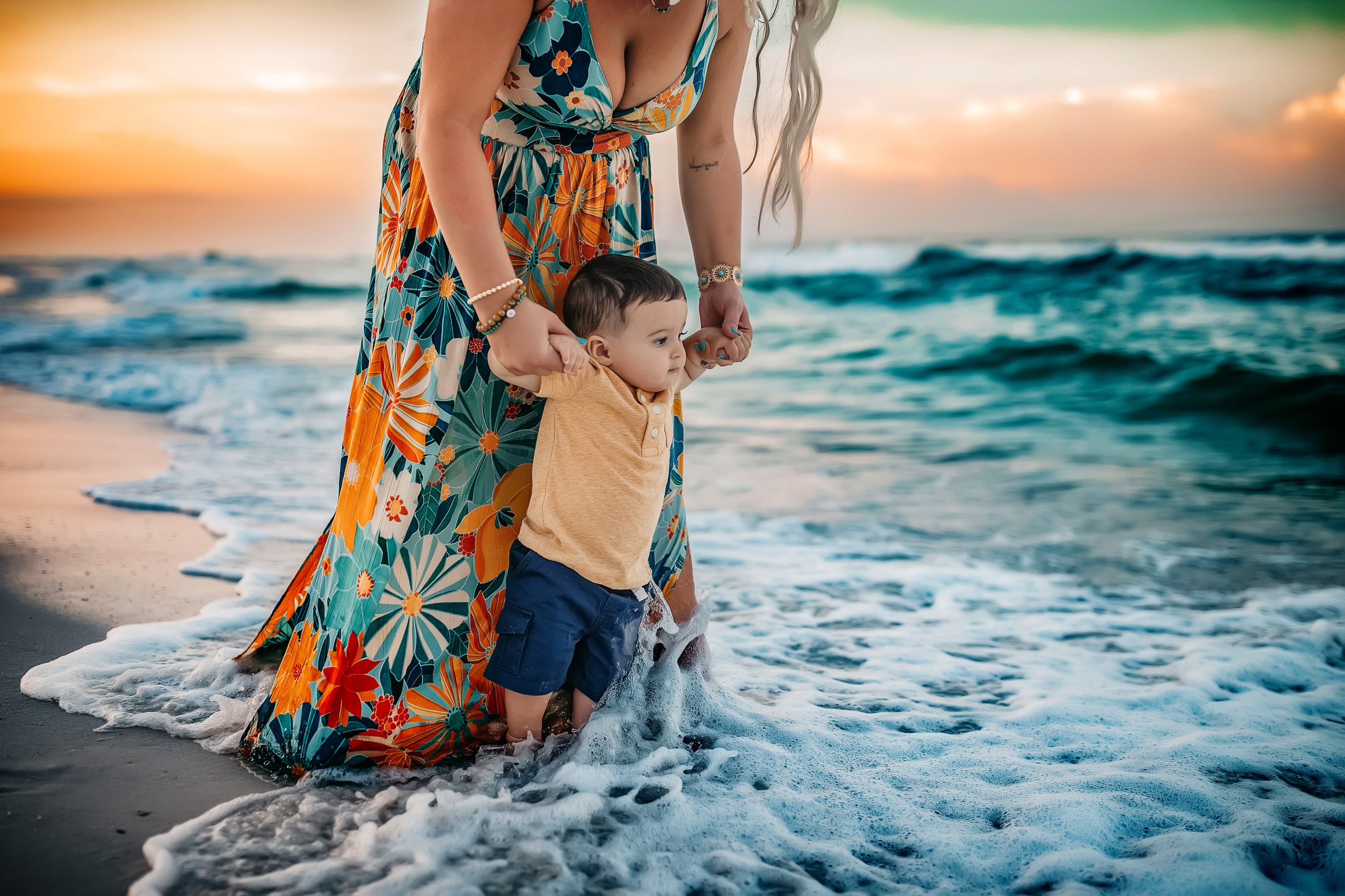 Mother and son playing in the shoreline during a sunset family session with a 30A family photographer in Rosemary Beach, Florida, capturing natural, candid beach portraits.