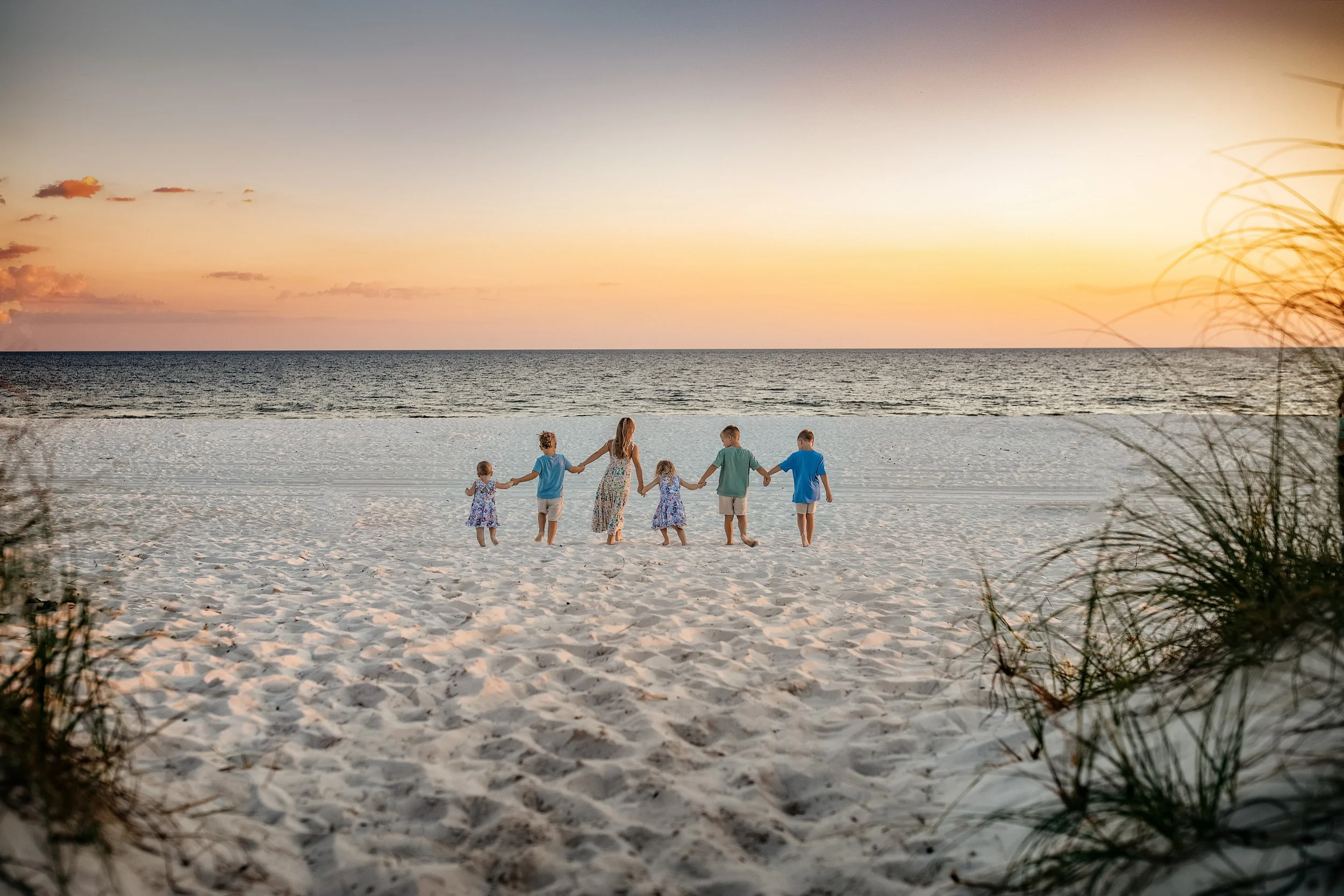 Sunset family beach photos on 30A with candid walking prompts, warm light, and relaxed posing ideal for families visiting Rosemary, Seaside, or Inlet Beach for vacation portraits.