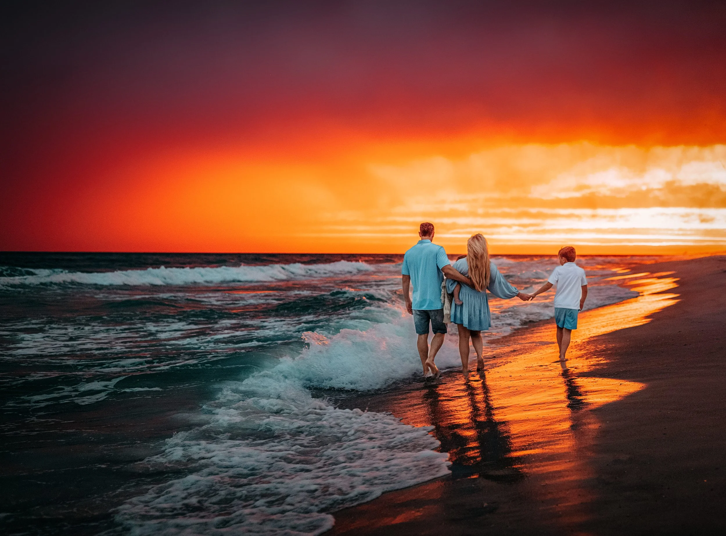 Family walking into the Gulf at sunset during Santa Rosa Beach family photo session with 30A photographer
