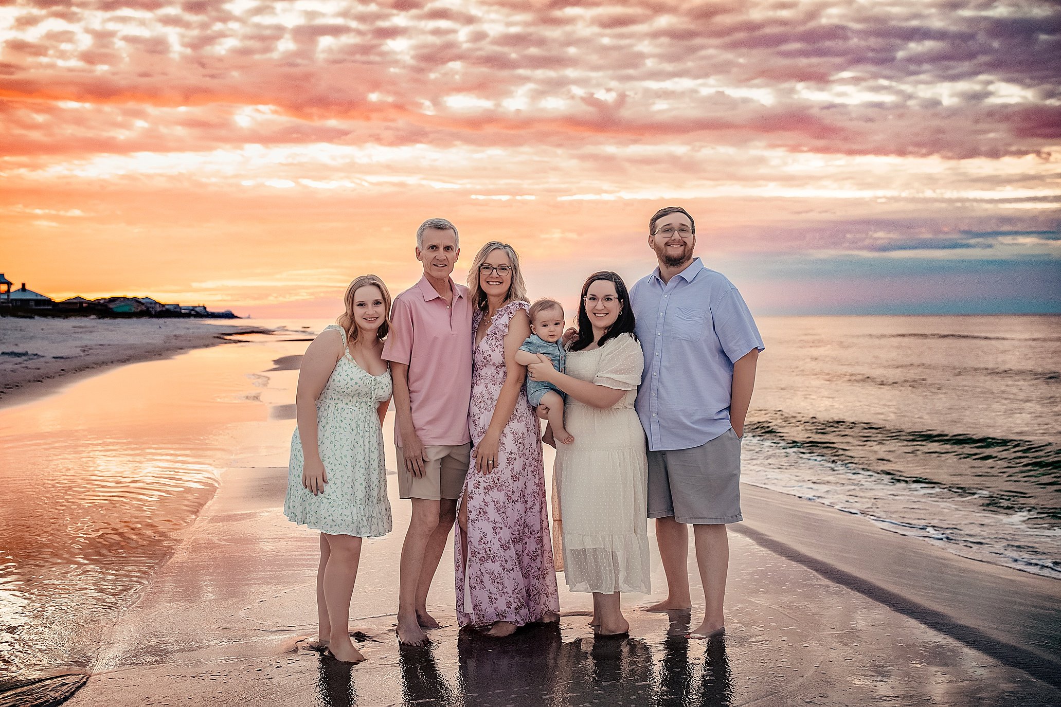 Extended family sunset session on 30A with warm golden light, pastel skies, and relaxed posing, perfect for multigenerational vacation portraits in Seaside, Alys Beach, or WaterSound.