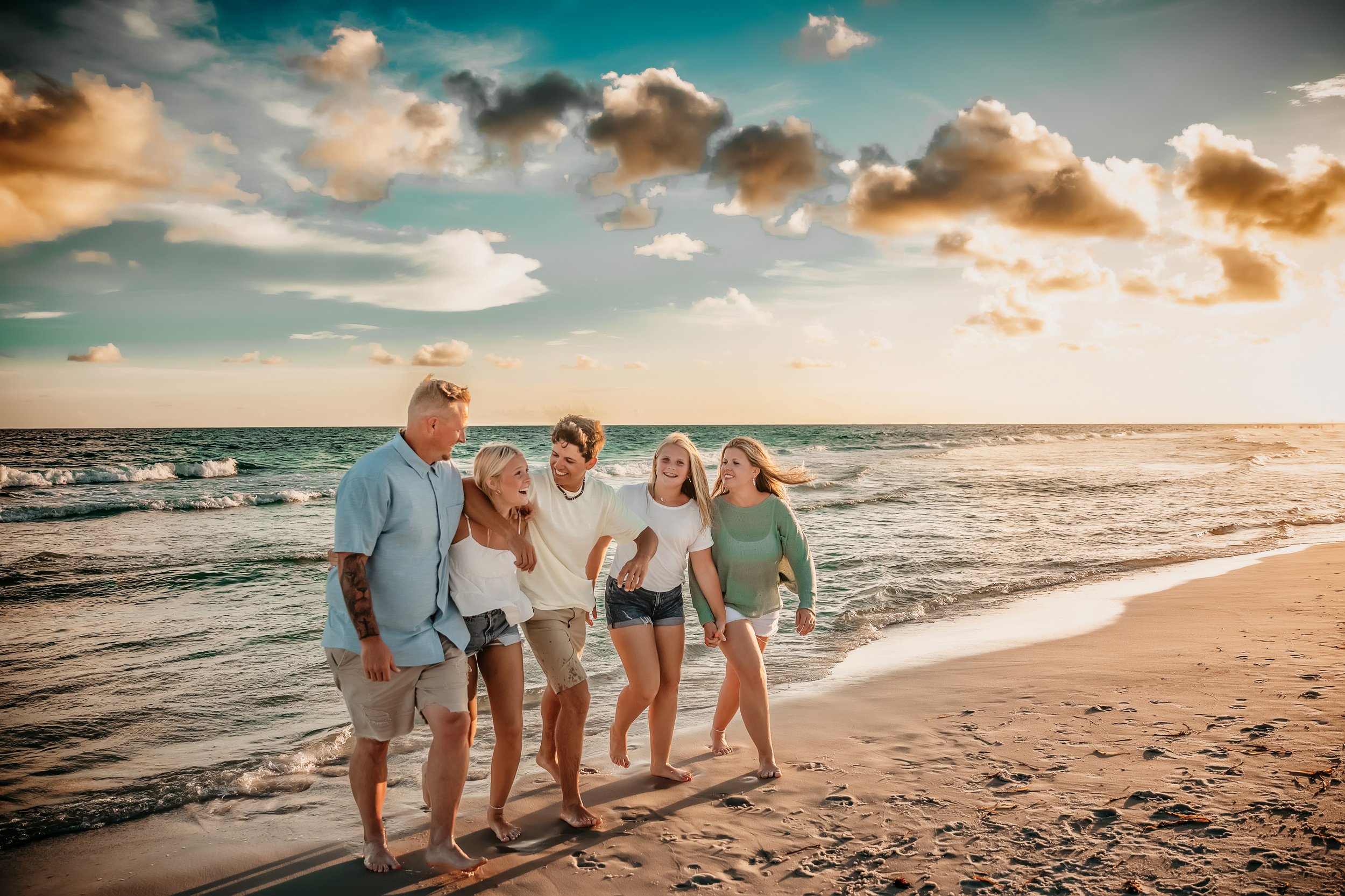 Grandparents and grandkids posing together on the wide beaches of Panama City Beach, Florida.