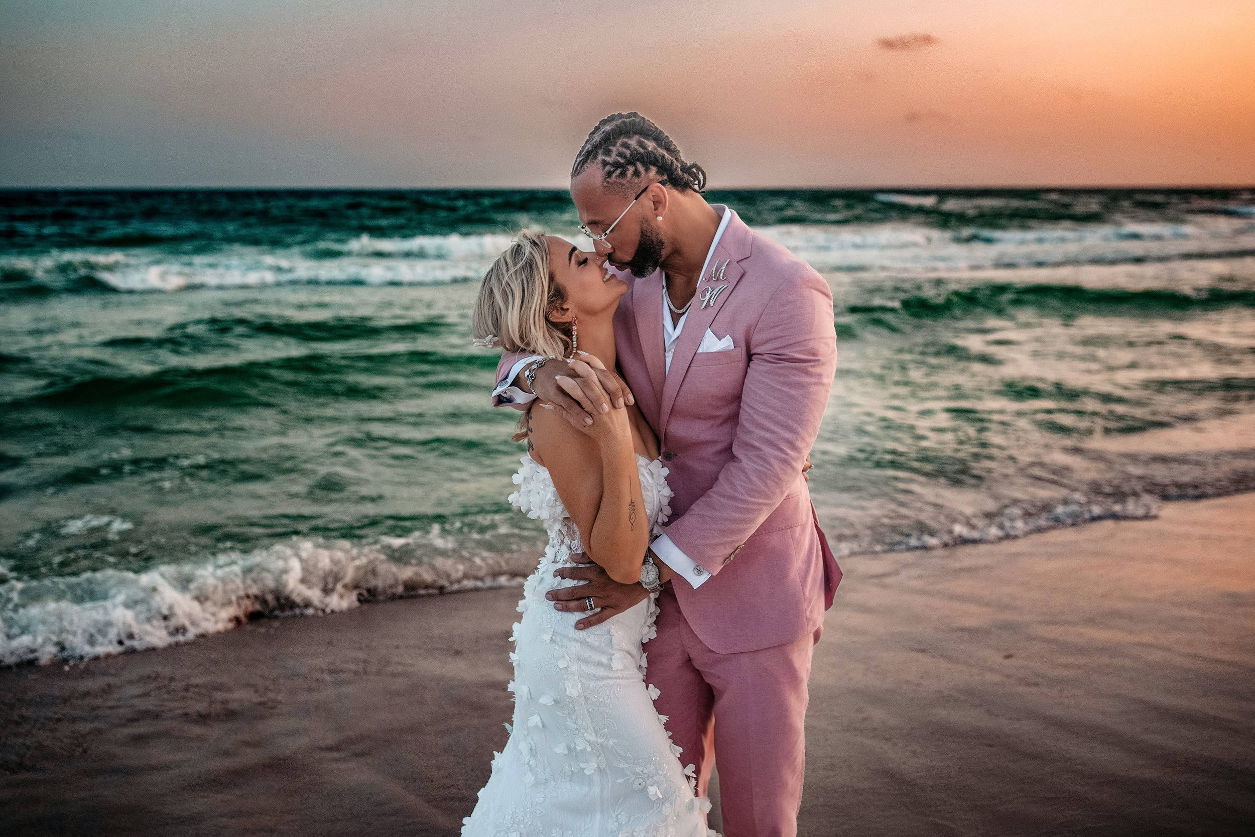 Bride and groom in ocean waves during 30A beach wedding