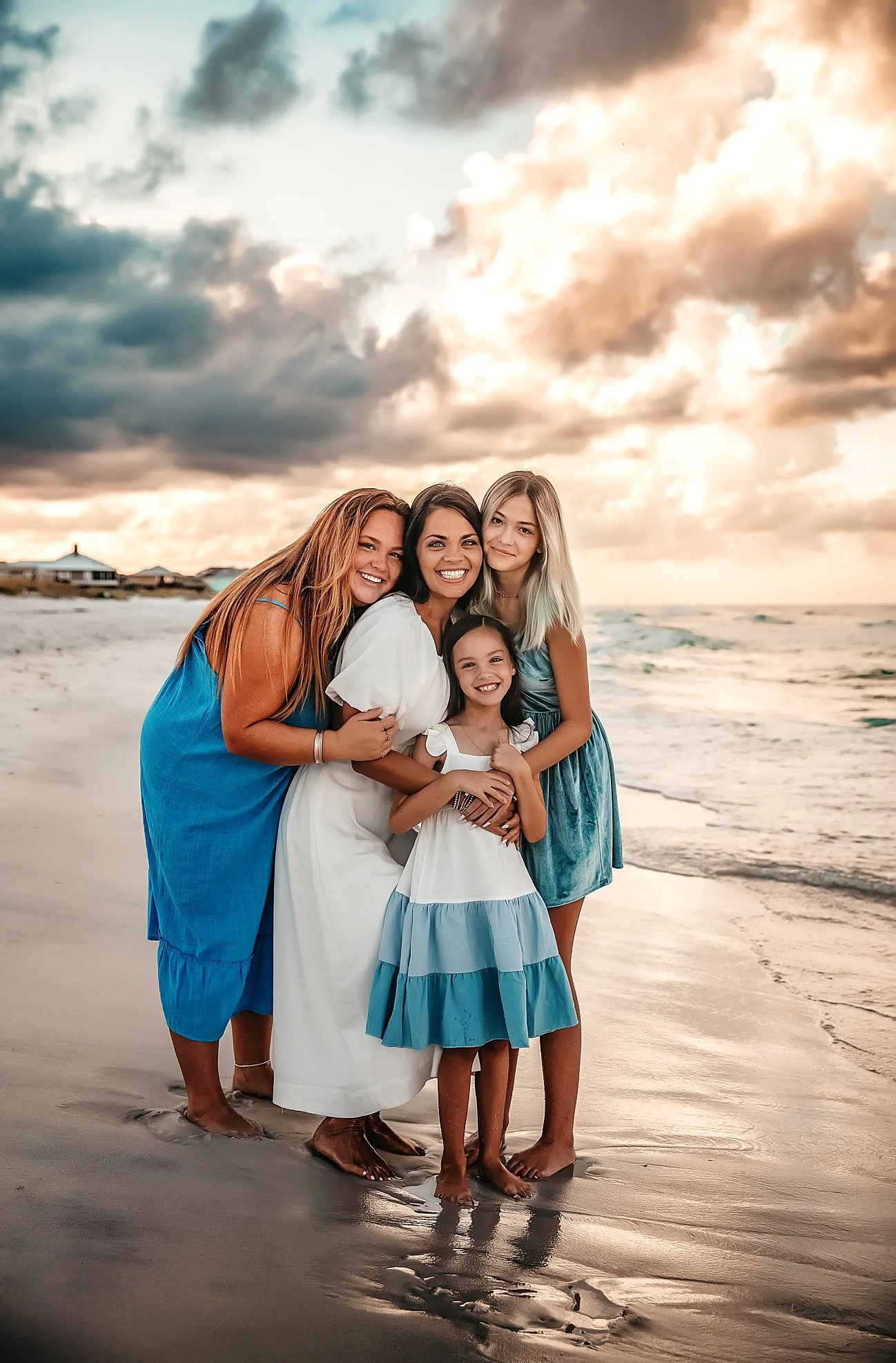 Mom with three daughters in coordinating blues and white on 30A Destin beach at sunset — Gulf Coast family photographer