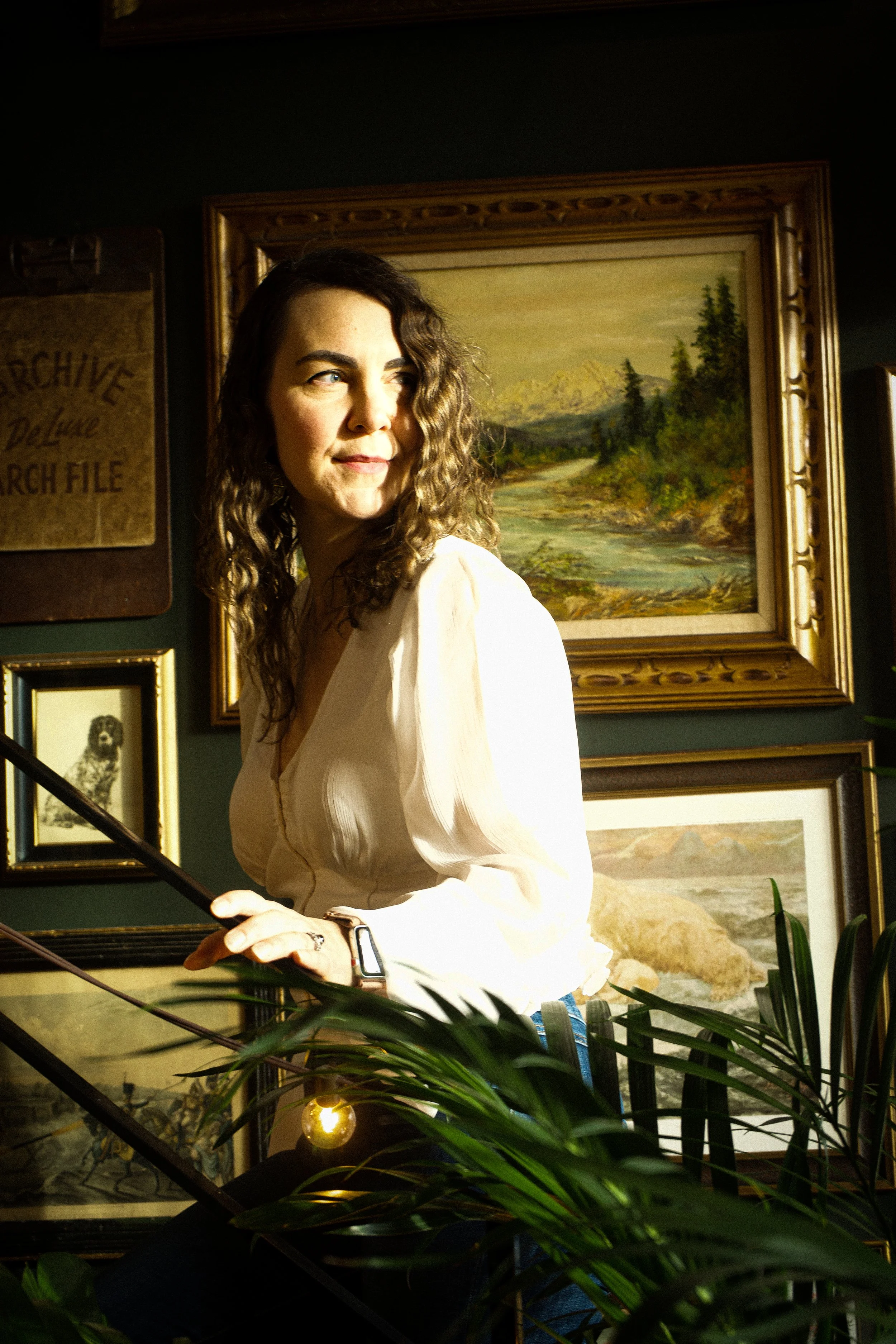 Image of Chelsea walking up stairs with lush gallery-style background