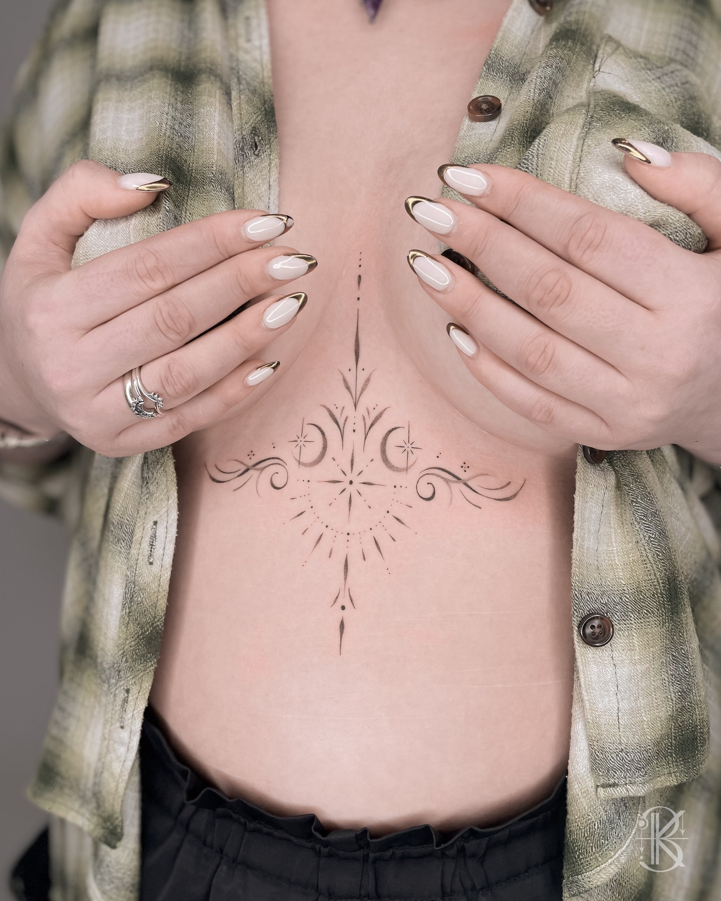 Fine line ornamental sternum tattoo by Karen Byers Ink, ornamental and black & grey tattoo artist based in Birmingham, UK - Featuring a mandala, moon and botanical elements.