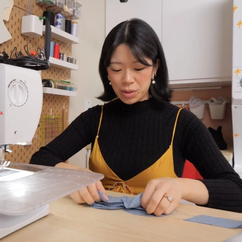 Fold the top layer into the centre and fold the outer layer, lining up the raw edges and sandwiching the inner folds.