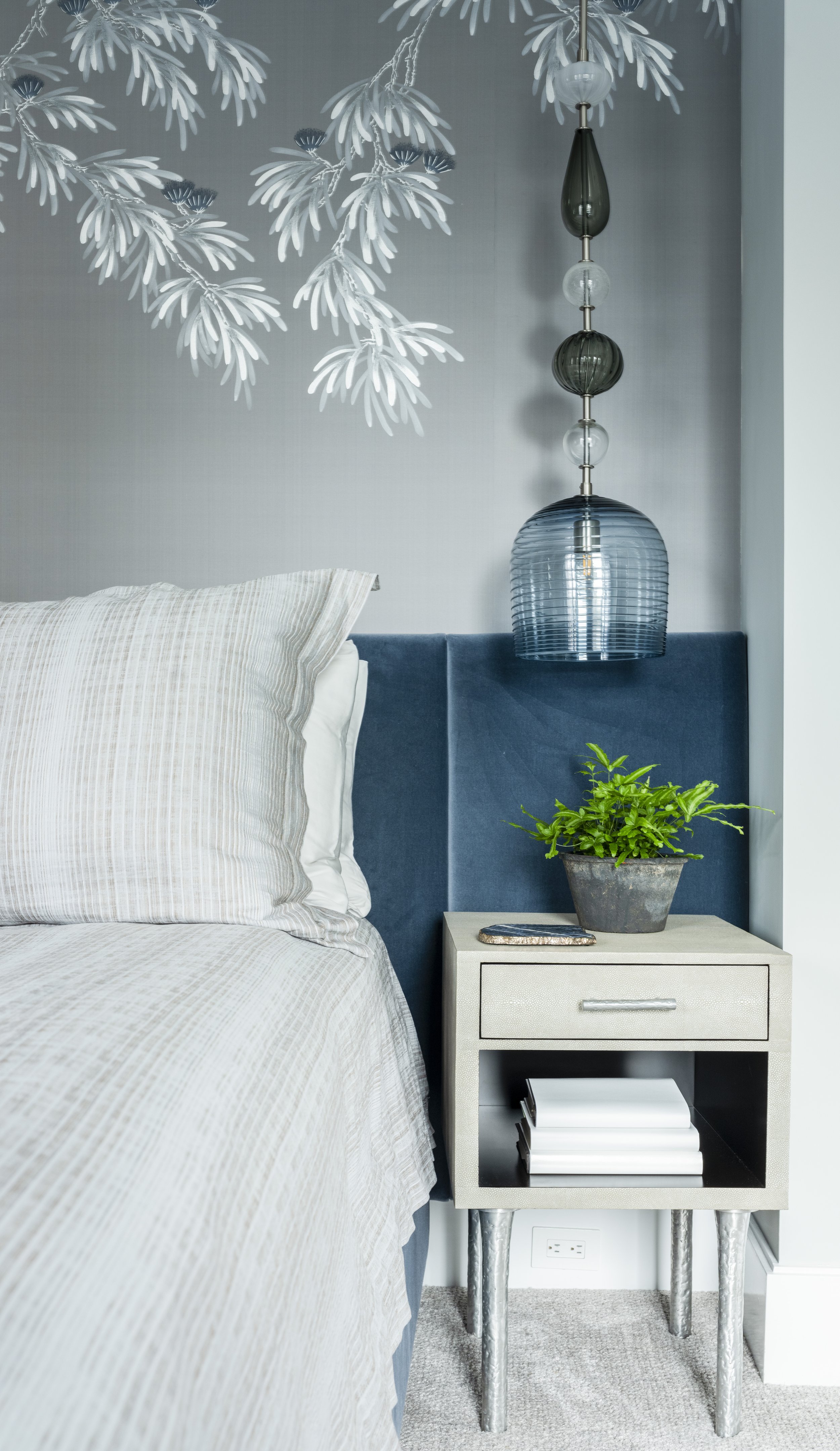 15-chic-side-table-blue-accent-patterned-bedding-and-wallpaper.jpg