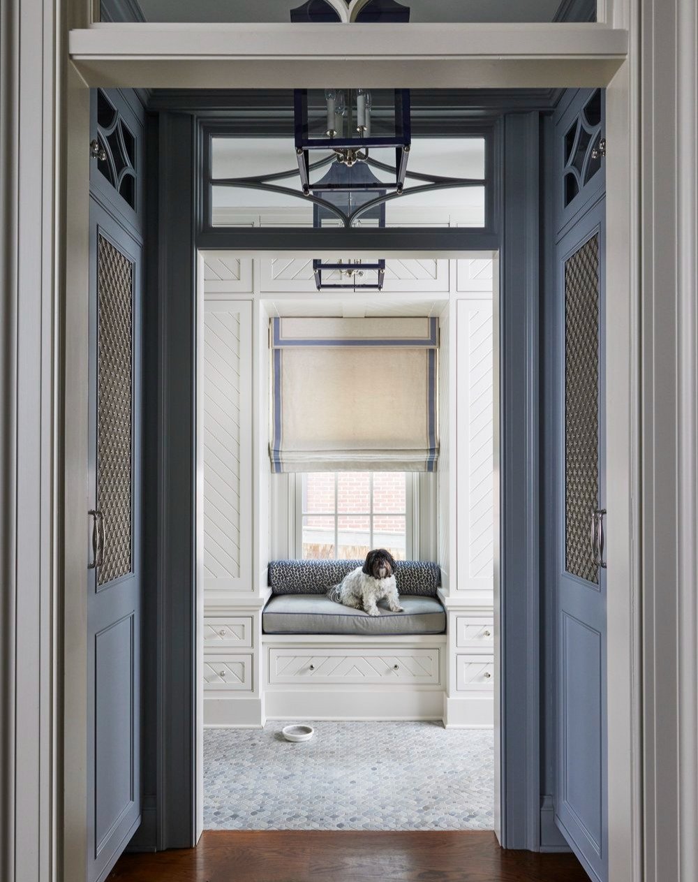 The dog days of summer are here, and Pearl is on patrol 🐾 We design for every member of the family &mdash; even the four-legged ones! This bright, cheerful mudroom has become her favorite spot to keep a watchful eye on her home (and maybe catch a na