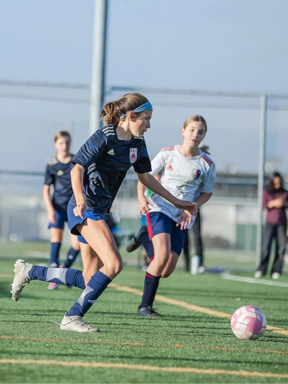 Eastshore Alliance FC girls competitive soccer player drives the ball forward during a high-intensity match in the San Francisco Bay Area. EAFC's Competitive Program empowers youth athletes with elite training and competition.