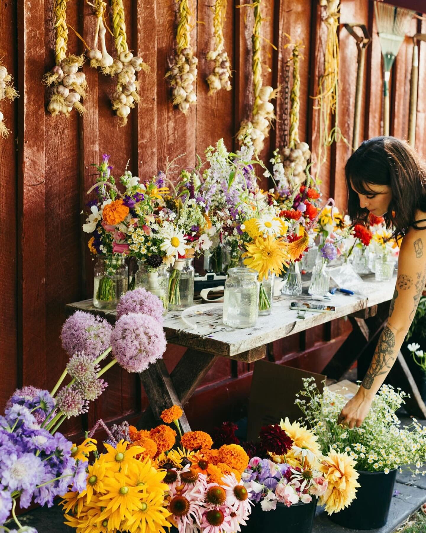 Physically, we&rsquo;re all here gearing up for the long dark winter ahead; but mentally, I&rsquo;m here: arranging flowers on the side of a red barn, surrounded by every color of locally grown wildflowers, sweating profusely in nearly 100 degree wea