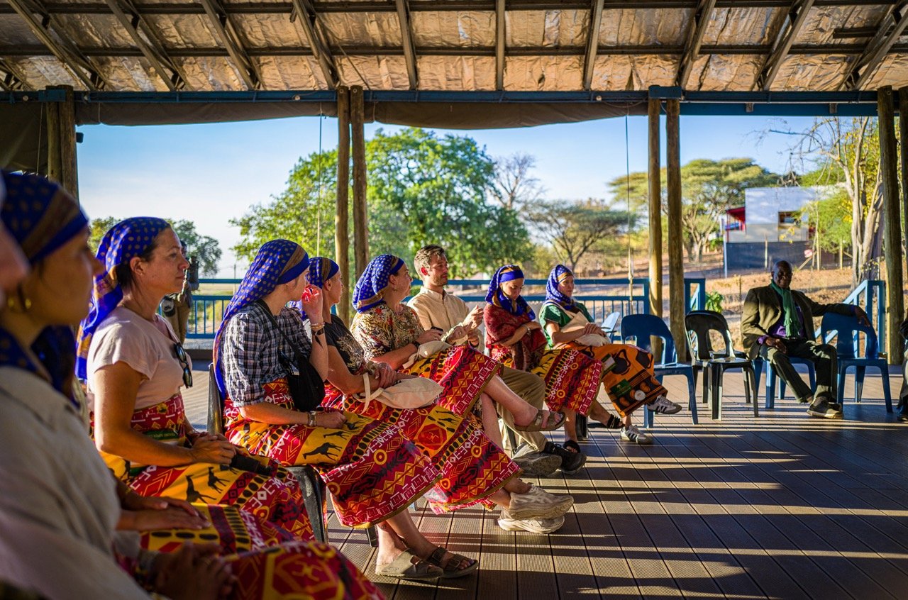 Retreat guests participating in a cultural workshop with members of a local Botswana community