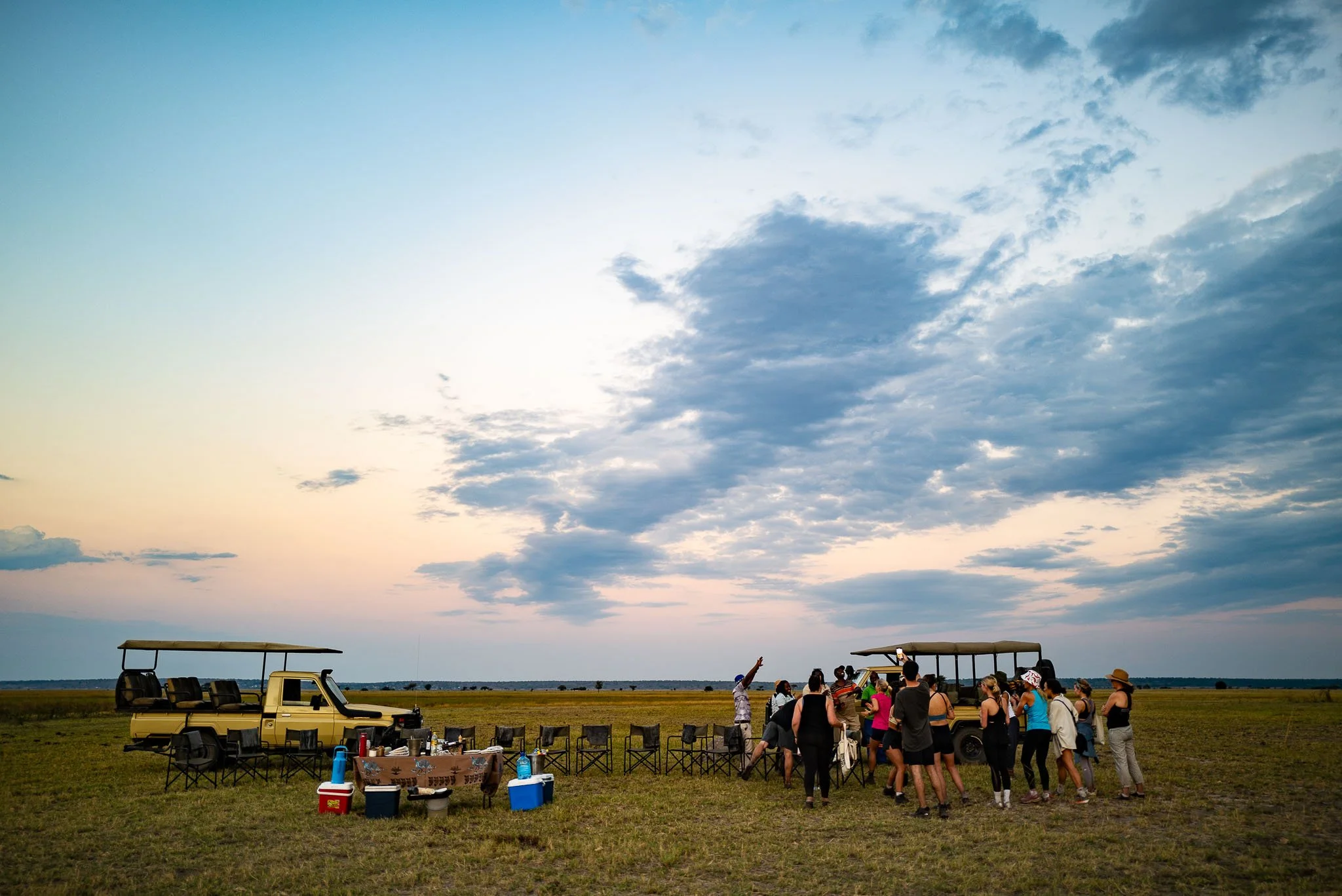 Safari vehicles travelling through the open landscape of Chobe National Park in northern Botswana