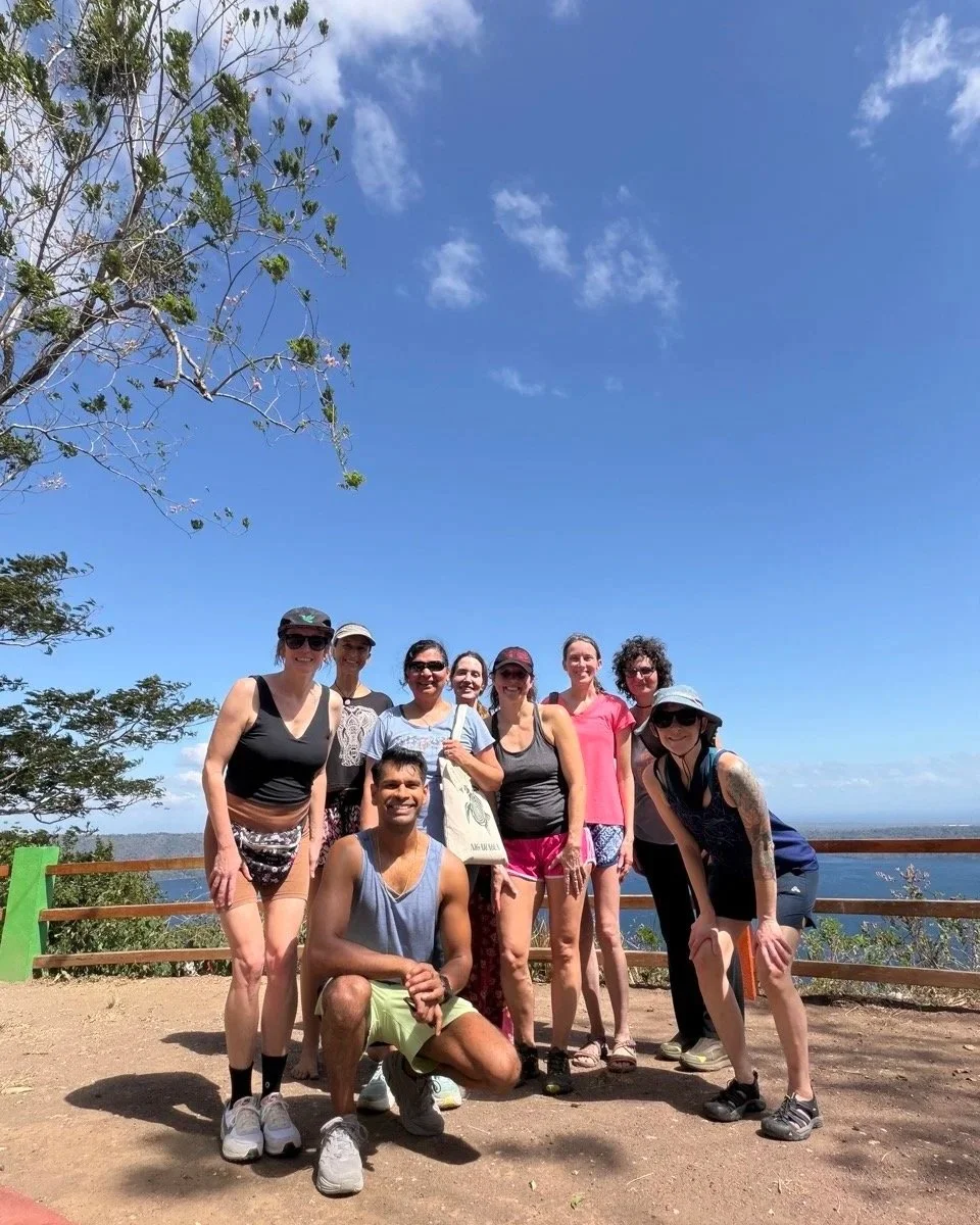 Happy retreat group hiking to viewpoint over Laguna de Apoyo Natural Reserve