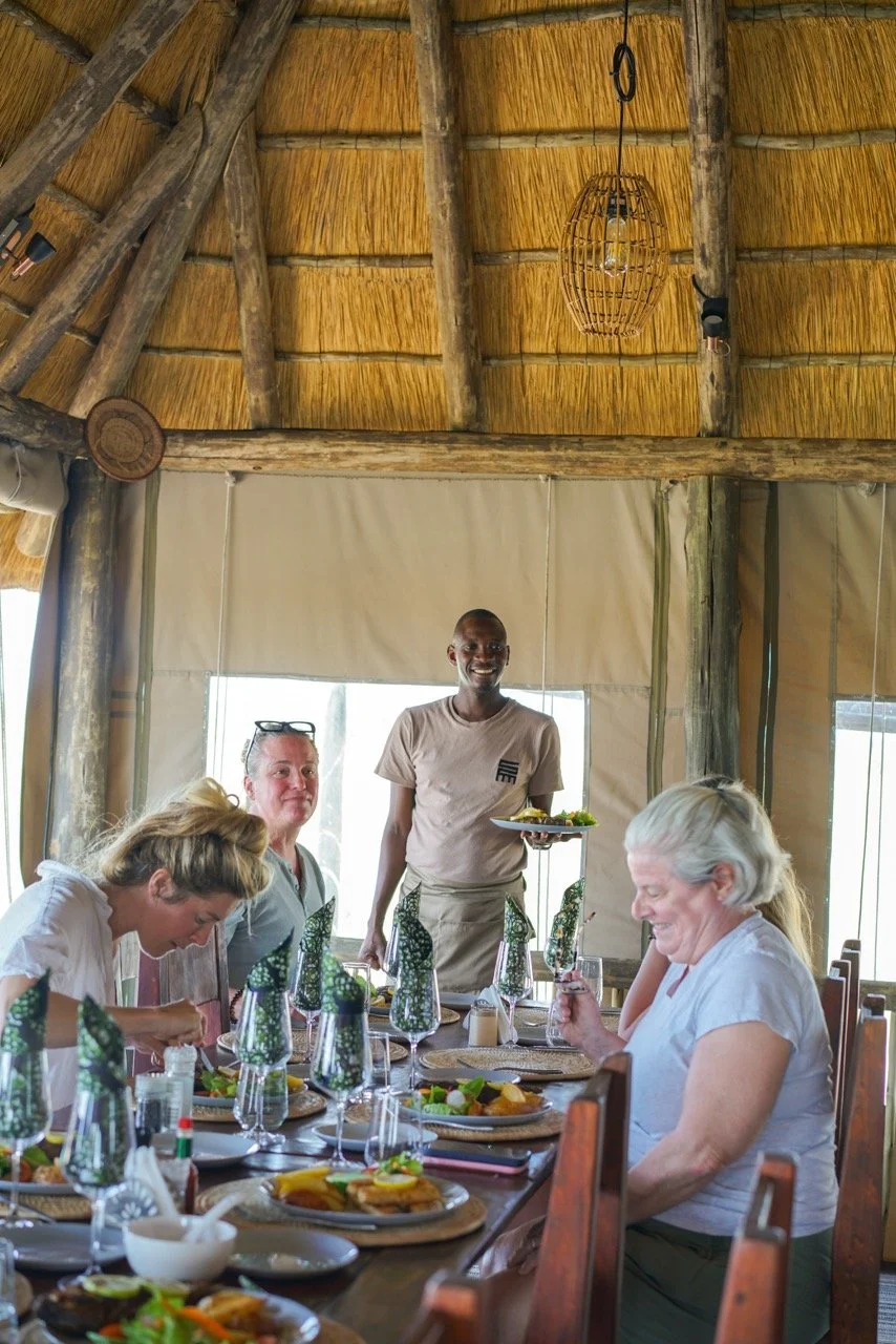 Retreat guests sharing a meal at Munga Plains yoga and safari camp in Botswana