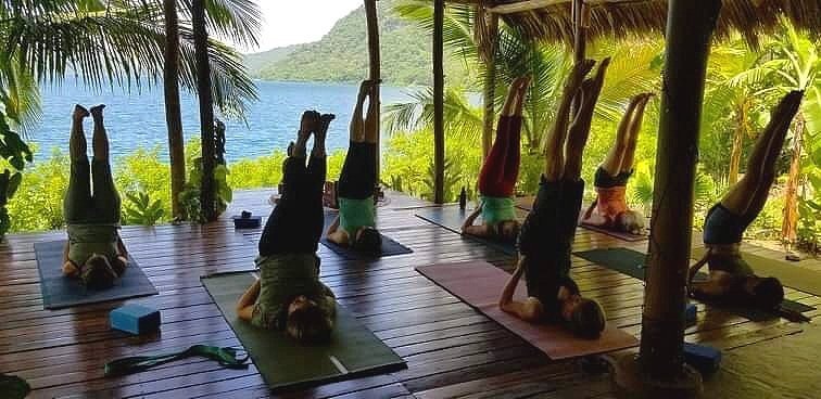 Students practicing yoga at a retreat in Nicaragua, with morning and evening classes held in a waterfront shala.