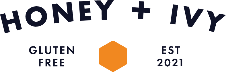 Draft of logo for Honey & Ivy with arched text and orange hexagon icon.