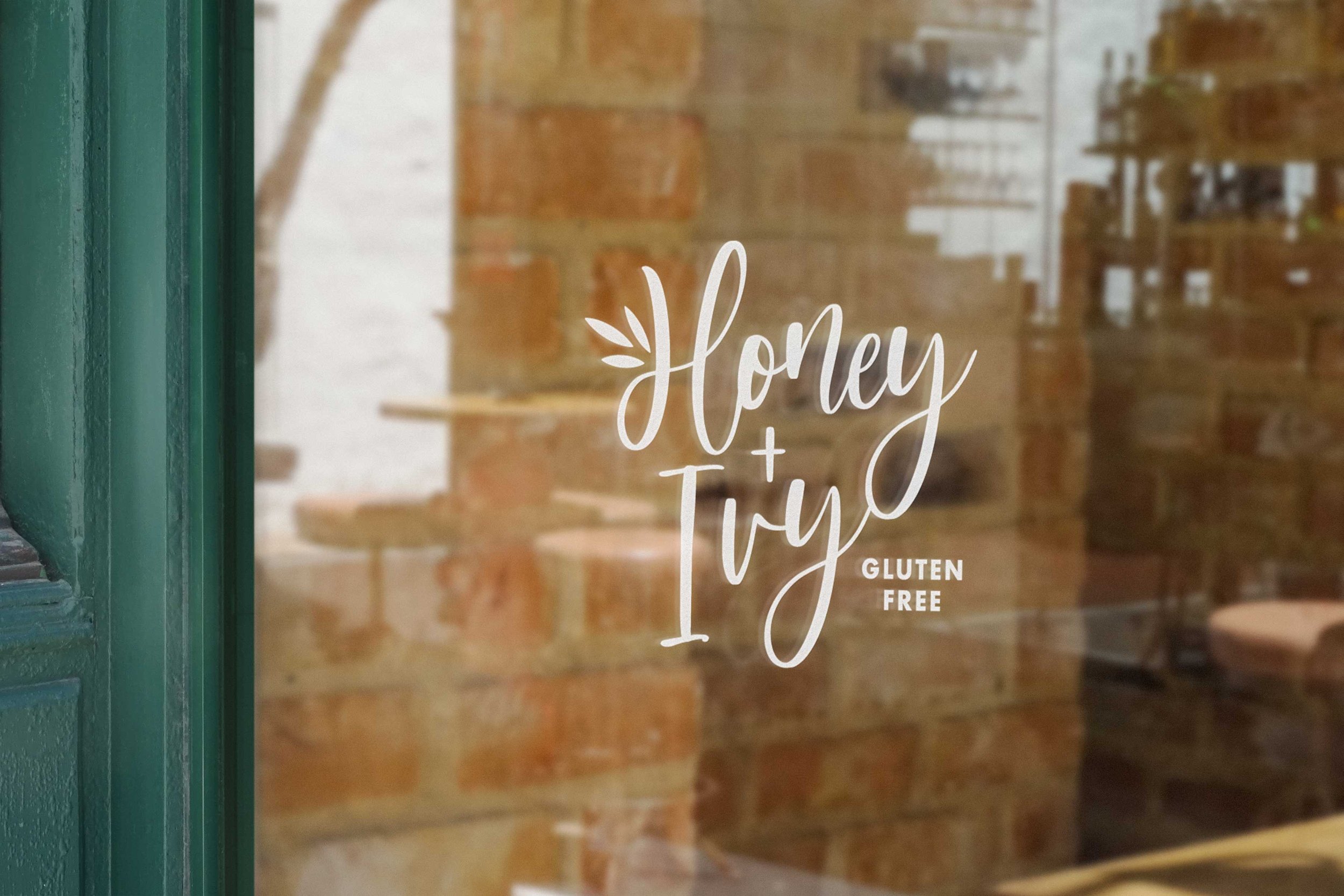 Glass storefront window the white Honey and Ivy bakery logo.