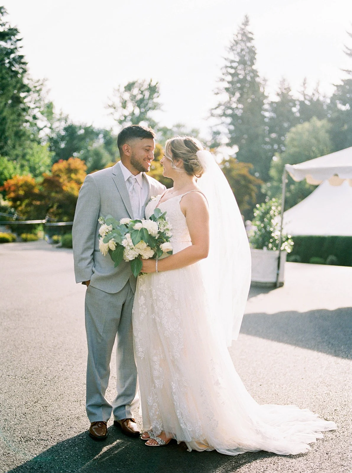 Bride and groom standing together in warm sunlight during their garden wedding at Abernethy Center.