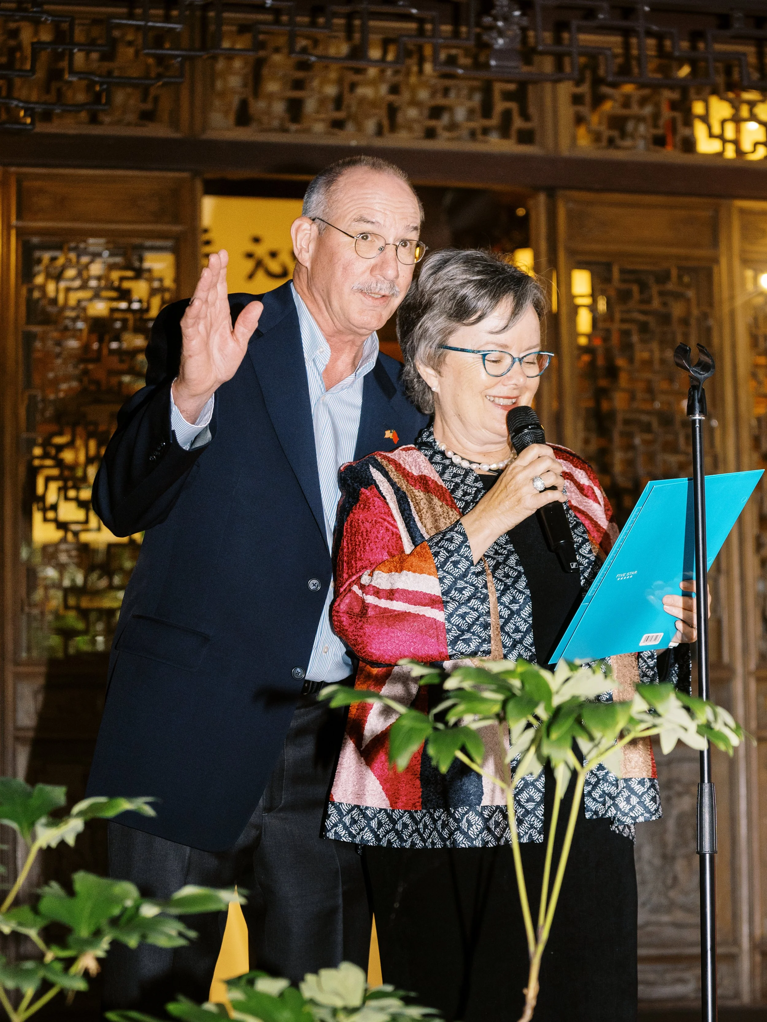 Family members giving a heartfelt speech during a wedding reception at Lan Su Chinese Garden in Portland.