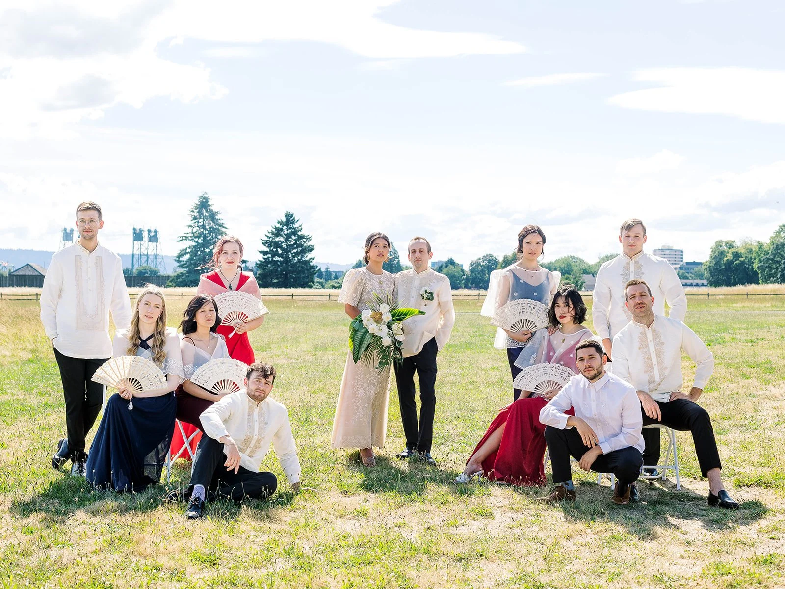 Wedding party portrait outdoors at Pearson Field wearing traditional Filipino wedding attire, including Filipiniana dresses and Barong Tagalog shirts.