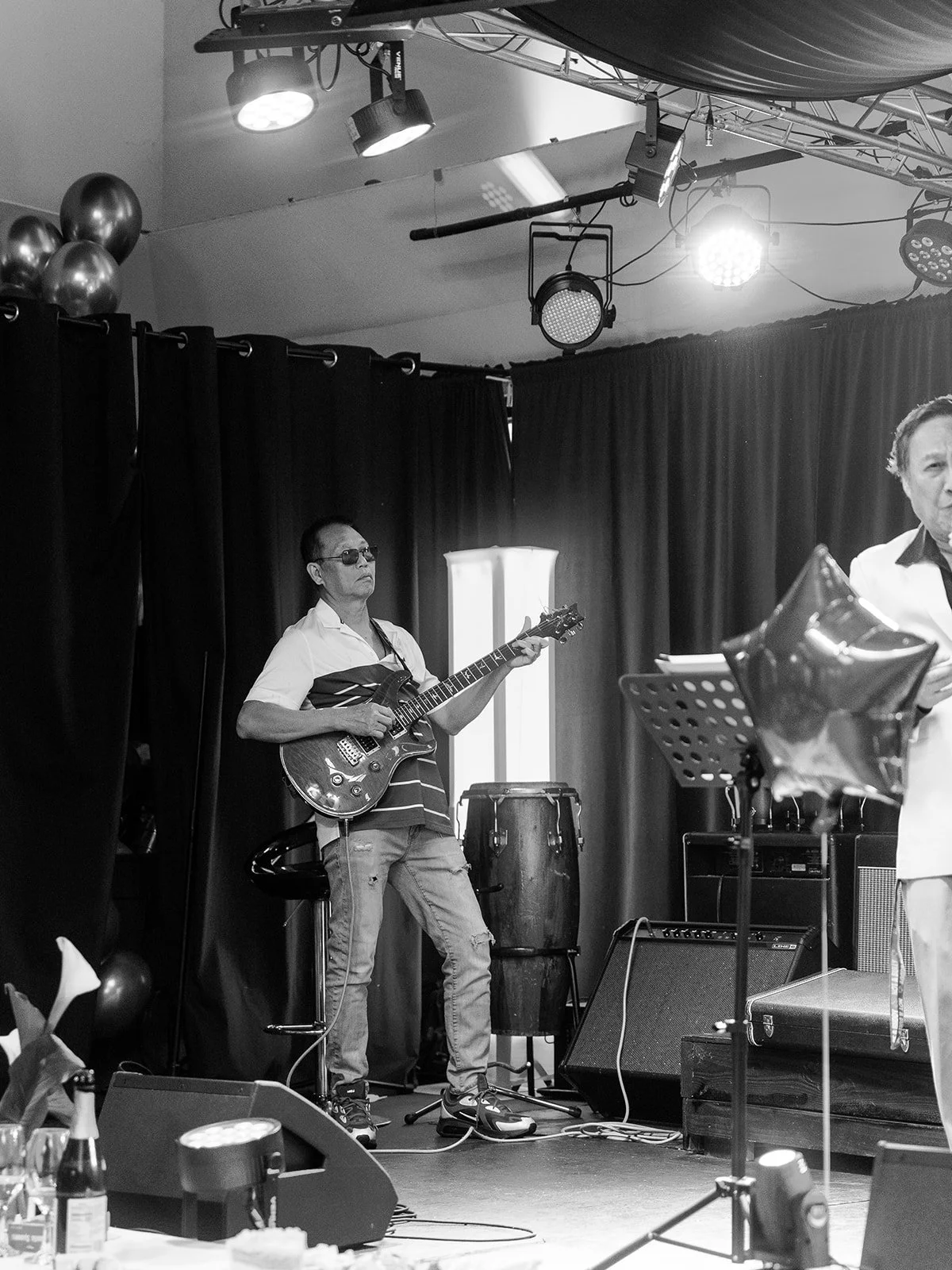 Guitarist playing on stage with the live band during the wedding reception.