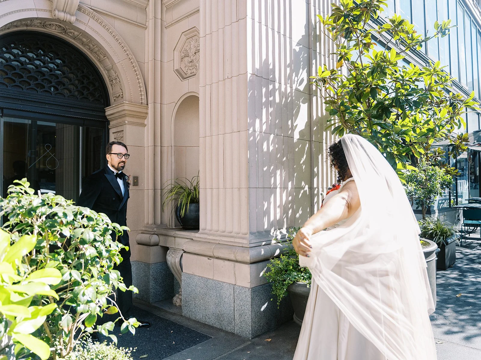 Groom turning to see bride during first look outside the Sentinel Hotel in Portland.