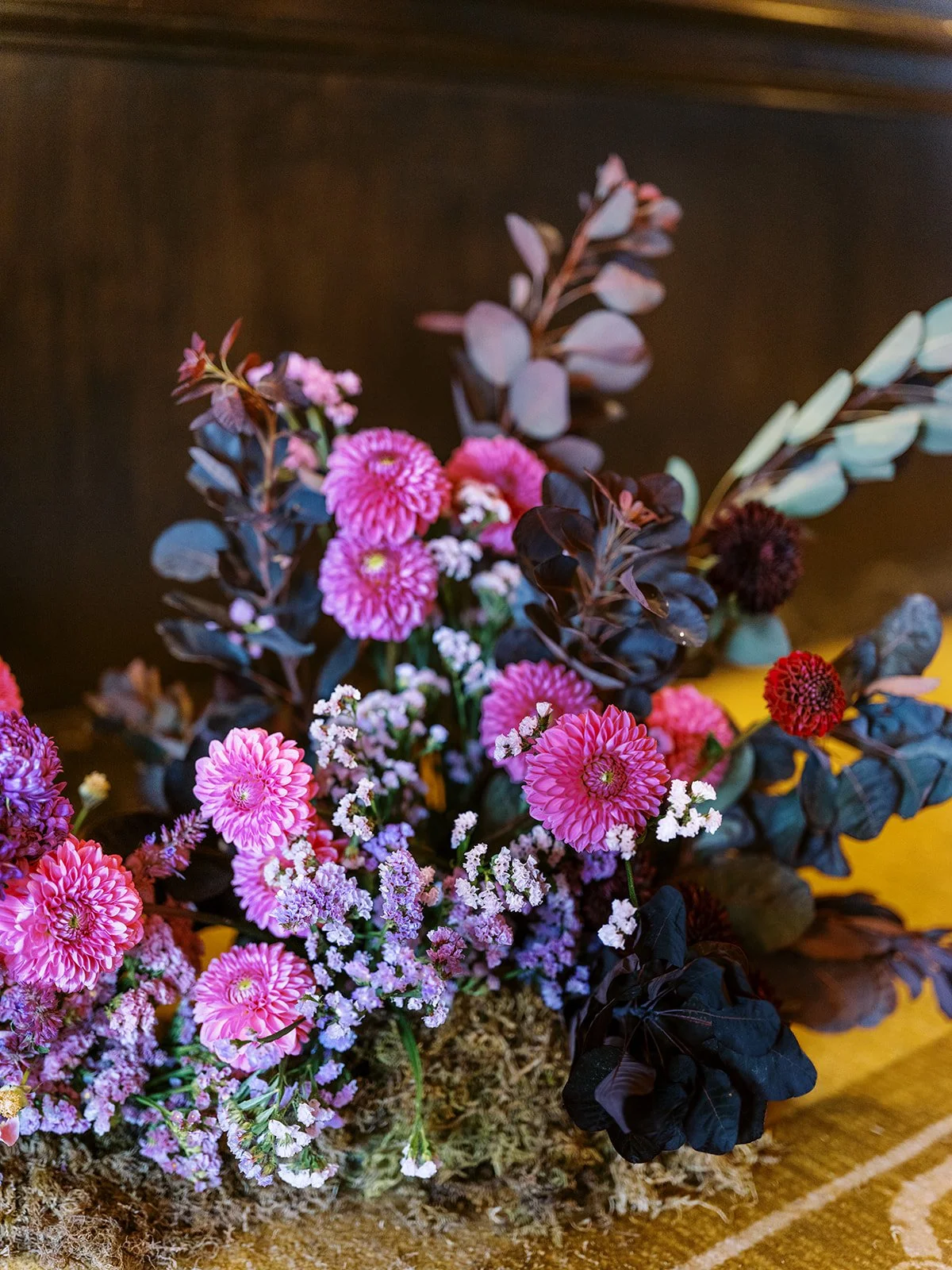 Pink and purple floral arrangement with dahlias and delicate filler flowers.