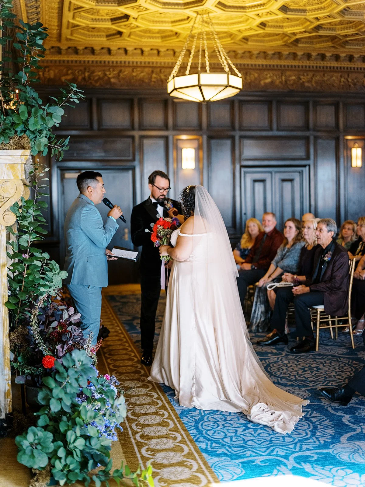Couple standing together during ceremony while officiant speaks.