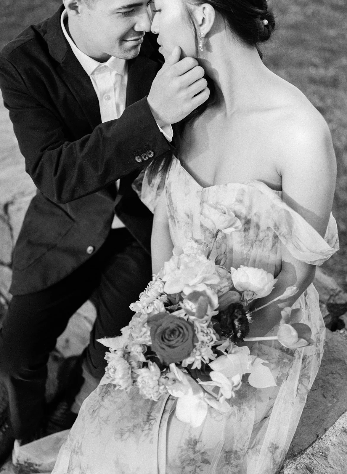Intimate black and white close-up of couple with bouquet at Cathedral Park.