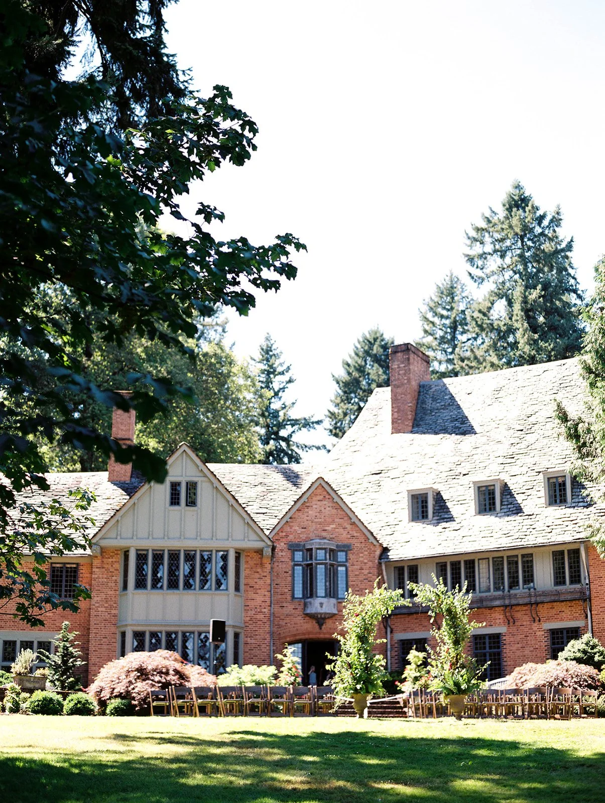 Historic estate building surrounded by trees and gardens at Lewis &amp; Clark College in Portland.