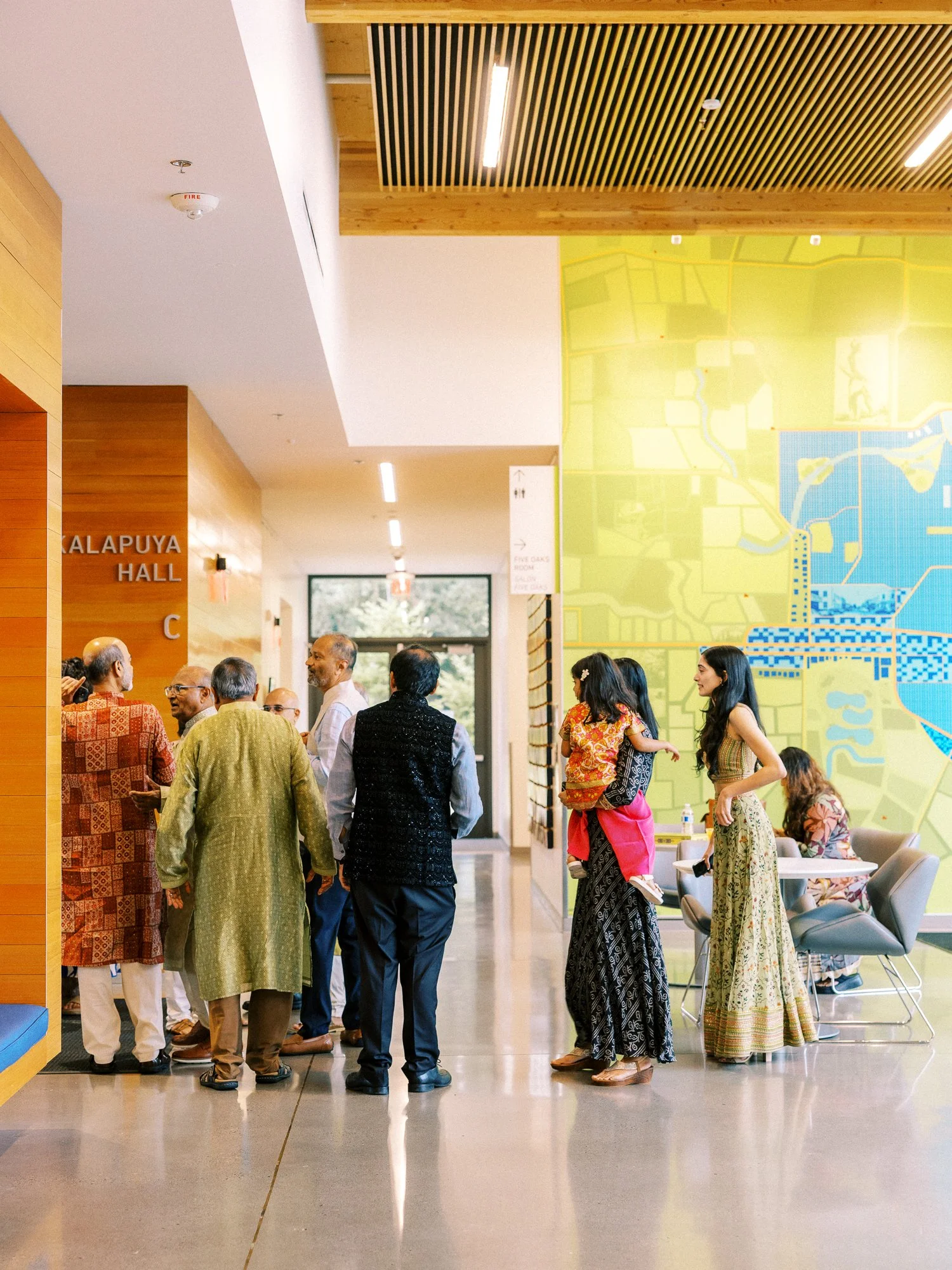 Guests in colorful traditional attire gathering inside the venue before the Mehndi ceremony.